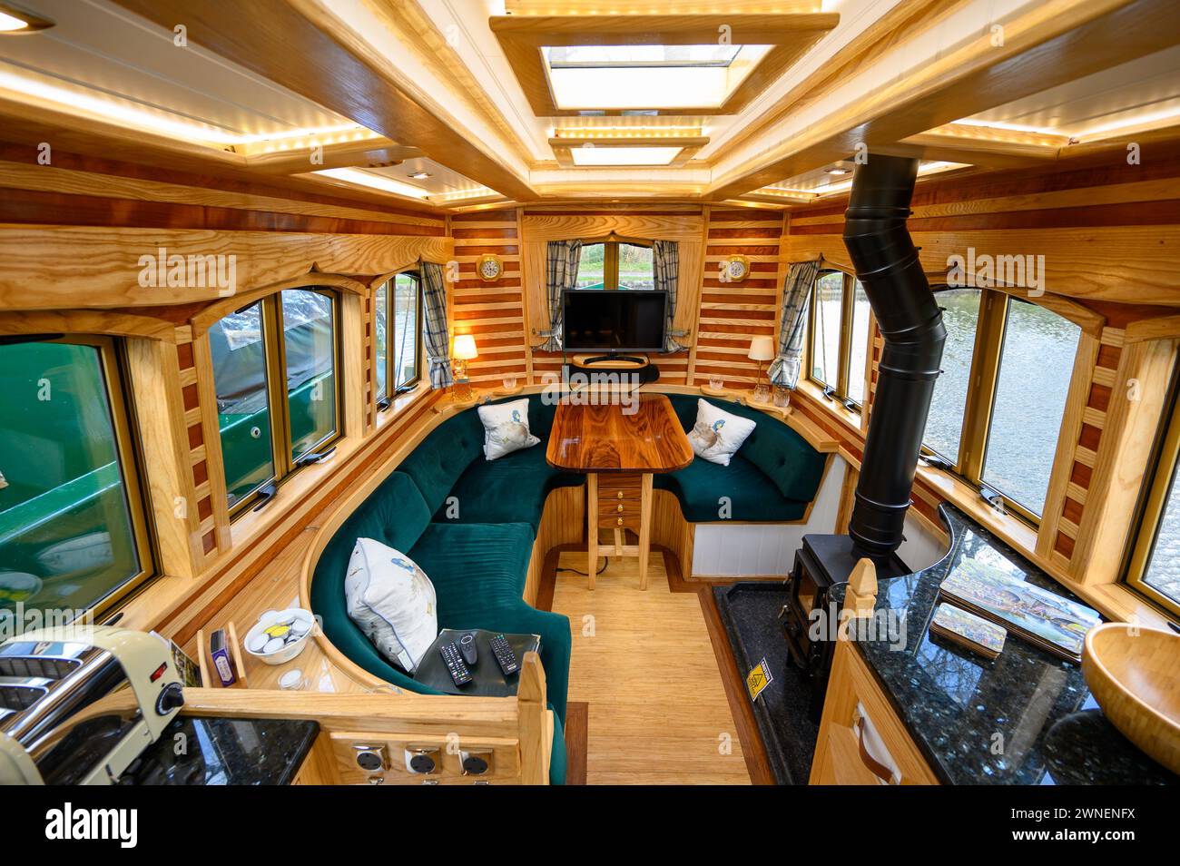 Eye catching interior of a holiday hire narrowboat with modern fixtures and fittings and distinictive wood patterns on the walls Stock Photo
