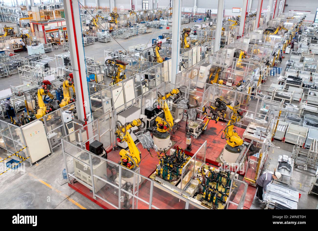 Beijing, China. 8th Jan, 2024. An aerial drone photo taken on Jan. 8, 2024 shows robotic arms processing parts for new energy vehicles at a private company in Changxing Economic and Technological Development Zone, Huzhou City, east China's Zhejiang Province. Credit: Tan Yunfeng/Xinhua/Alamy Live News Stock Photo