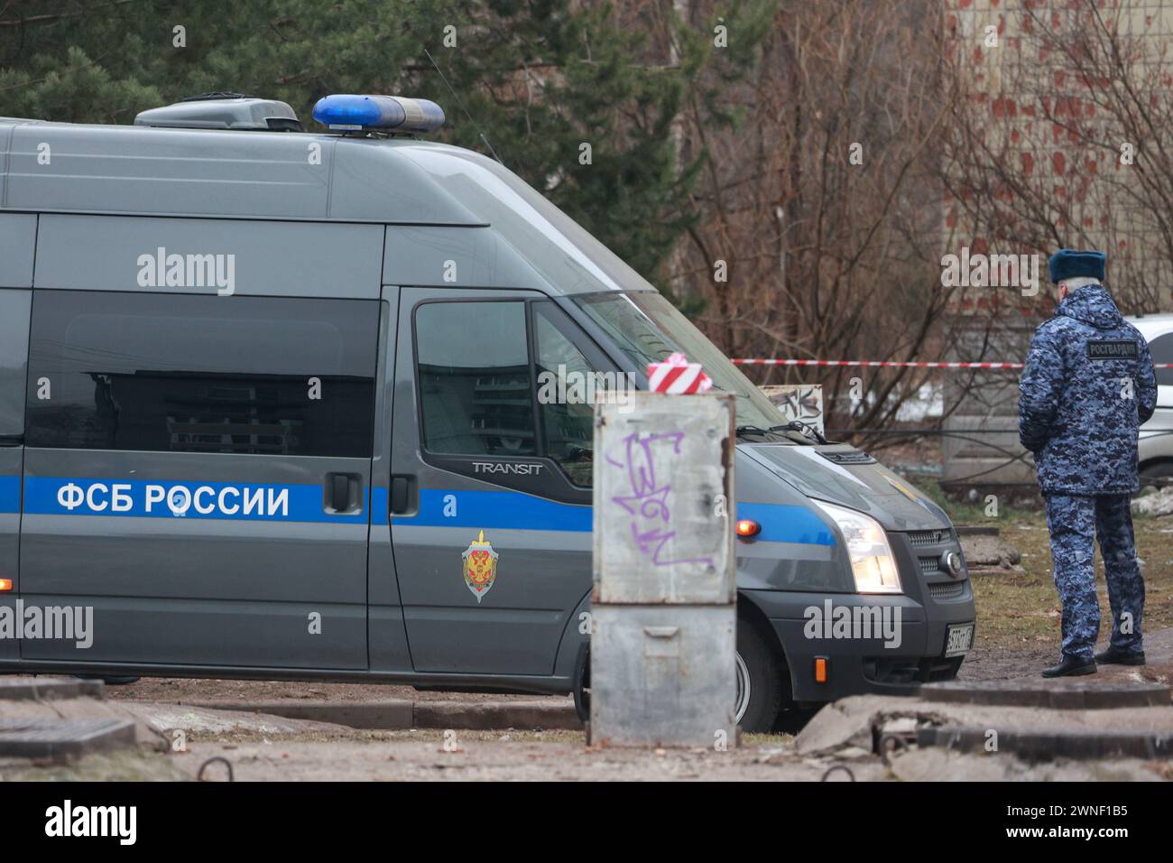 Saint Petersburg, Russia. 02nd Mar, 2024. A police van and a police officer seen around a damaged residential building after an alleged drone attack, which was reported by local media at Krasnogvardeisky district. The Russian Ministry of Emergency Situations take security measures around the building. Credit: SOPA Images Limited/Alamy Live News Stock Photo