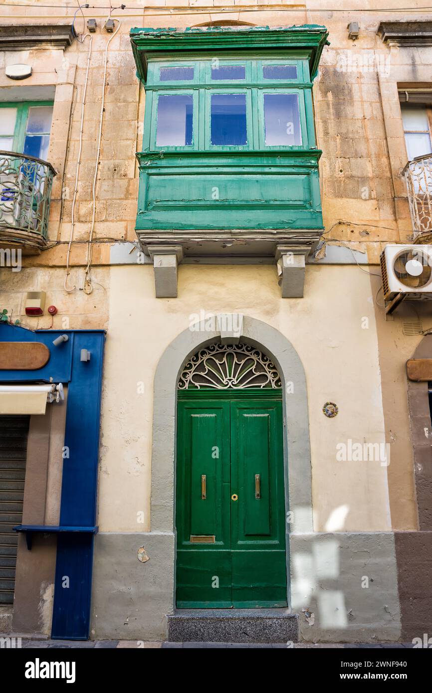 Facade of a typical house with balconies closed by typical Malta windows and doors Stock Photo