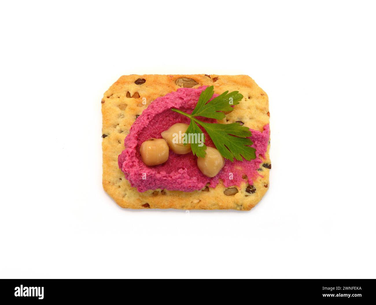 Beet hummus spread on a cracker isolated on white background Stock Photo
