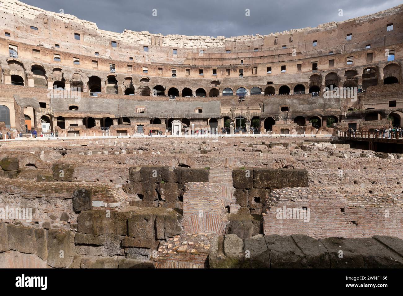 Rome, Italy - March 02, 2023: Tourists walking inside the Roman Colosseum in Rome, Italy Stock Photo