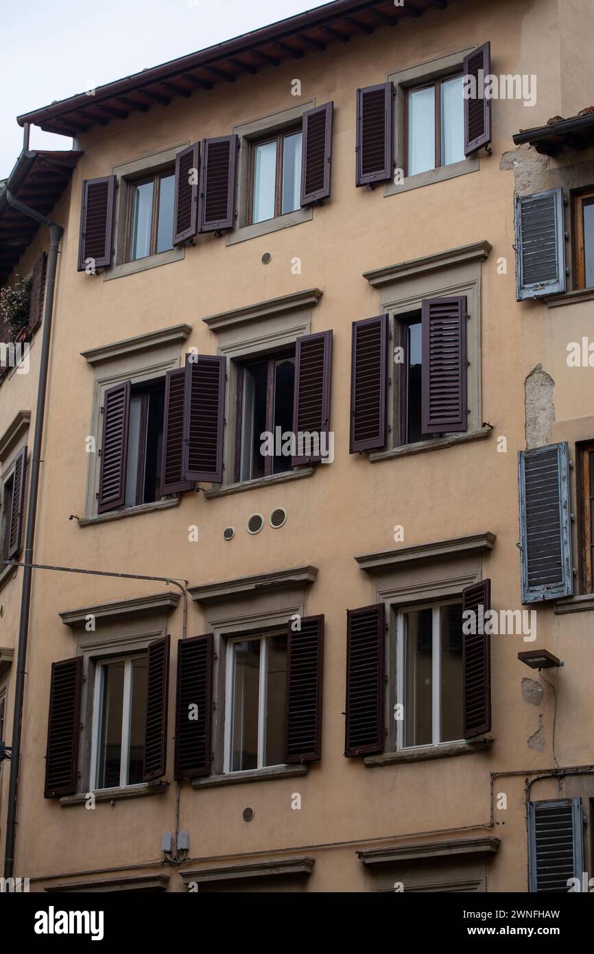facade of medieval building with traditional windows in Florence city, Tuscany, Italy Stock Photo
