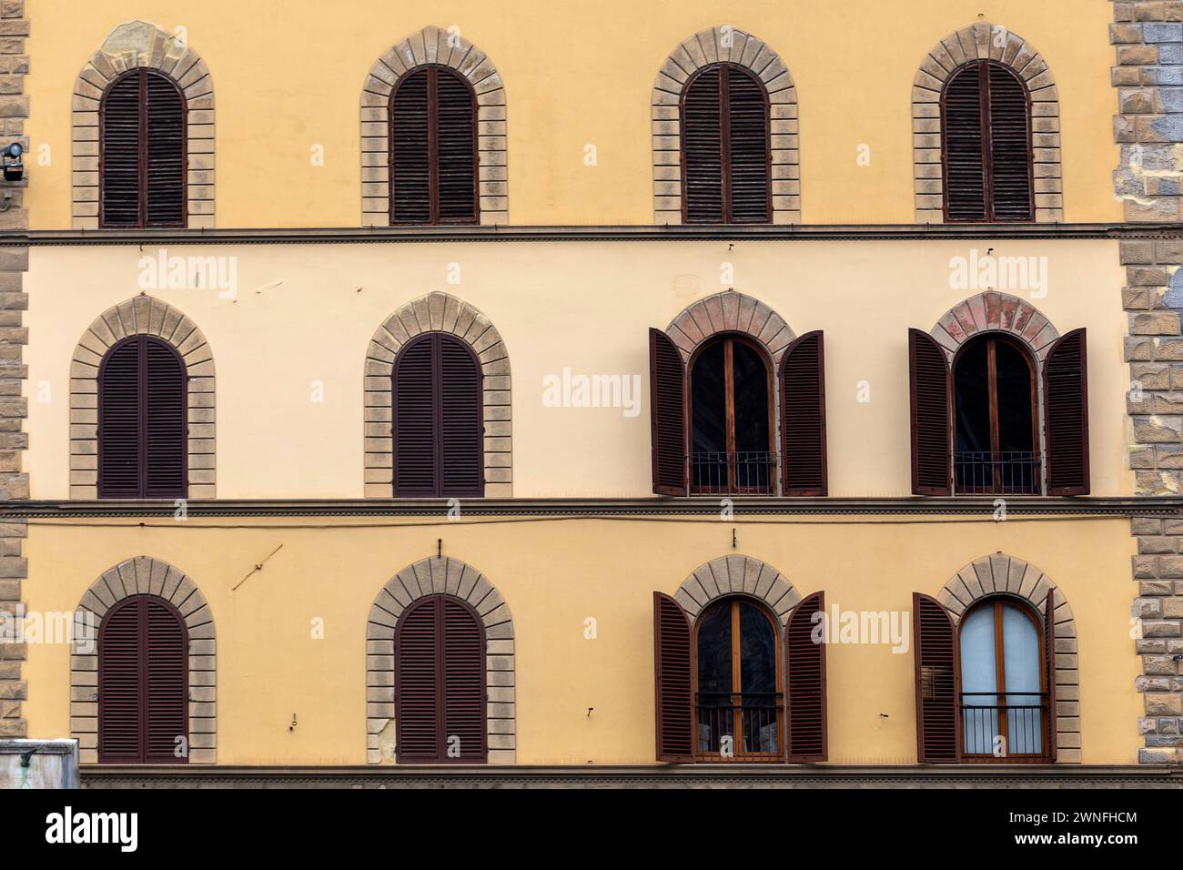 facade of medieval building with traditional windows in Florence city, Tuscany, Italy Stock Photo