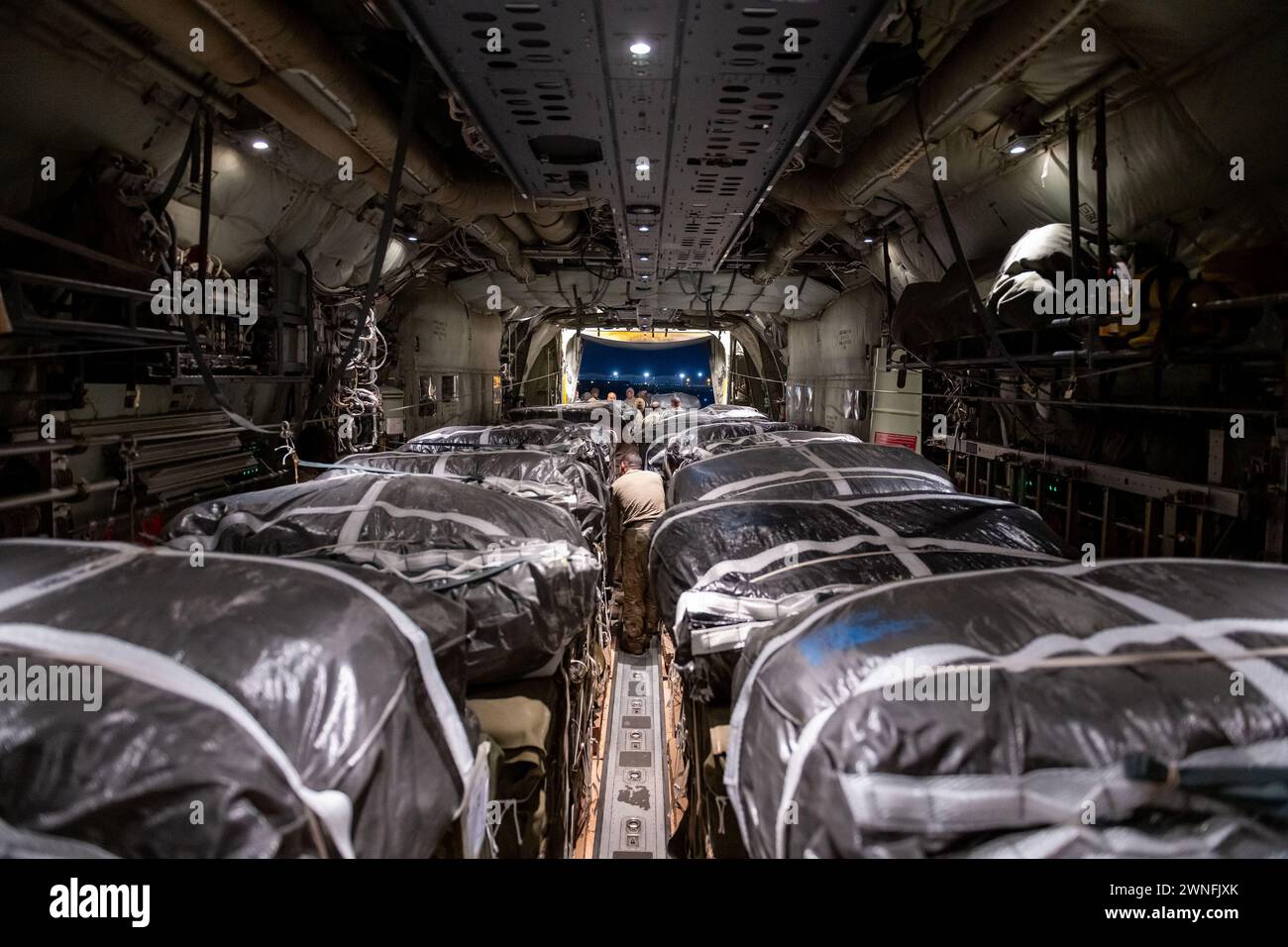 Humanitarian aid pallets rigged with parachutes for airdrop aboard a C-130J Super Hercules are loaded and prepared for takeoff at an undisclosed location in Southwest Asia, on Friday, March 1, 2024. The humanitarian assistance included 38,000 Meals Ready to Eat and water to alleviate suffering of civilians in Gaza. Photo via U.S. Air Force Courtesy/UPI Credit: UPI/Alamy Live News Stock Photo