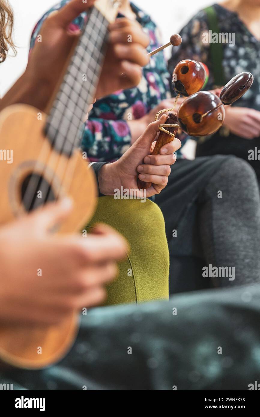 Group of people playing on different kinds of musical instruments ...