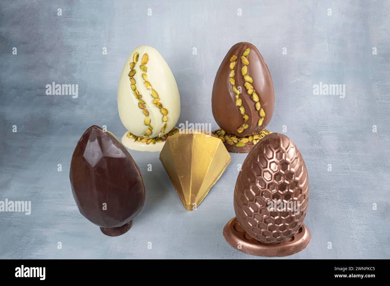 Assorted Easter eggs with pistachios, milk and dark chocolate_1. Stock Photo