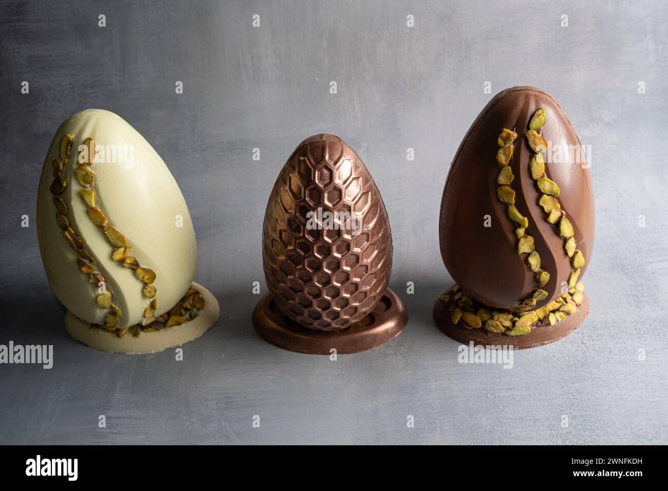Assorted Easter eggs with pistachios, milk and dark chocolate_Low key_4. Stock Photo