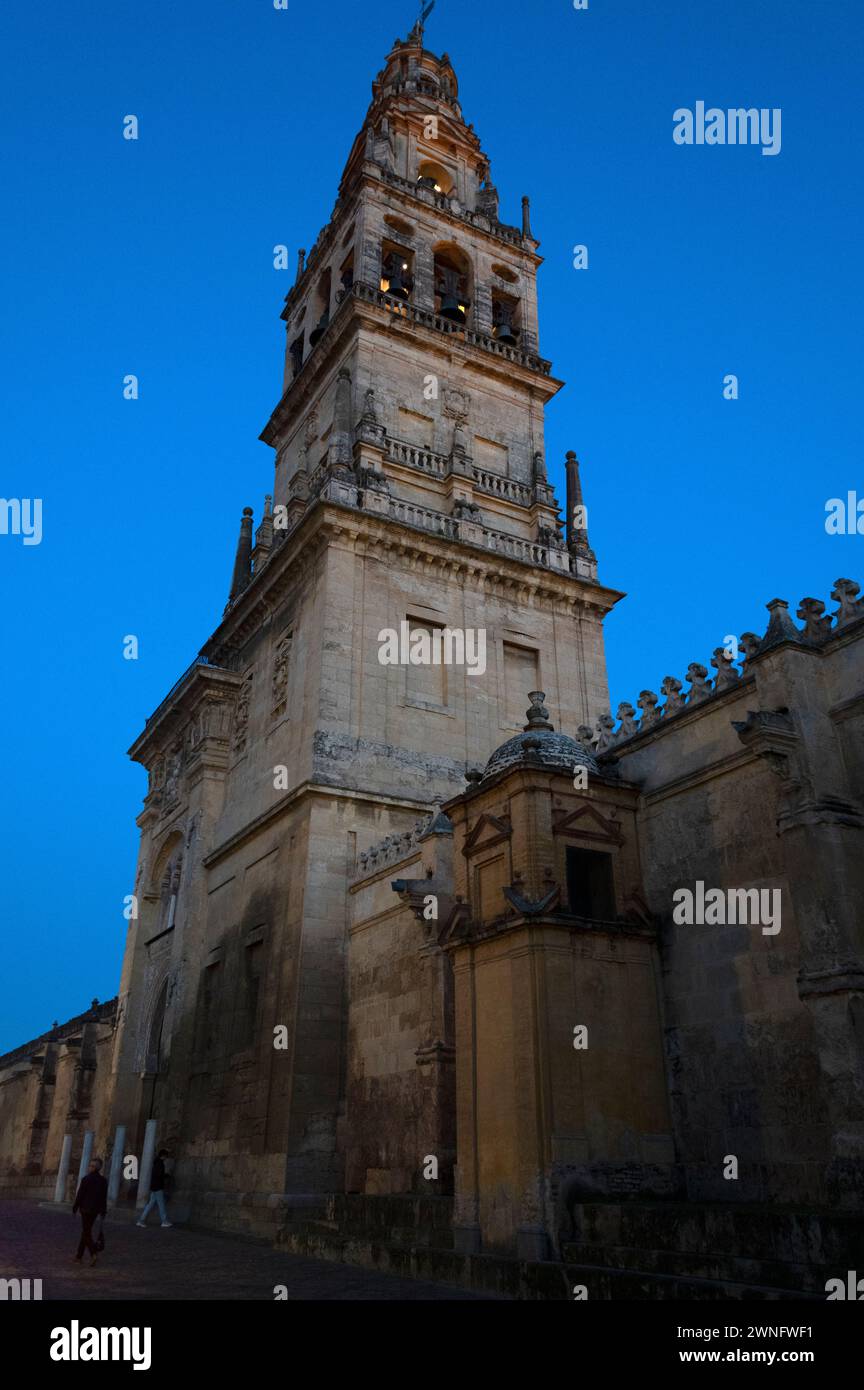 At dusk is the silhouette Bell tower, part of the Mosque/Cathedral in Cordoba in Andalusia, southern Spain.   The bell tower on the site of the former Stock Photo