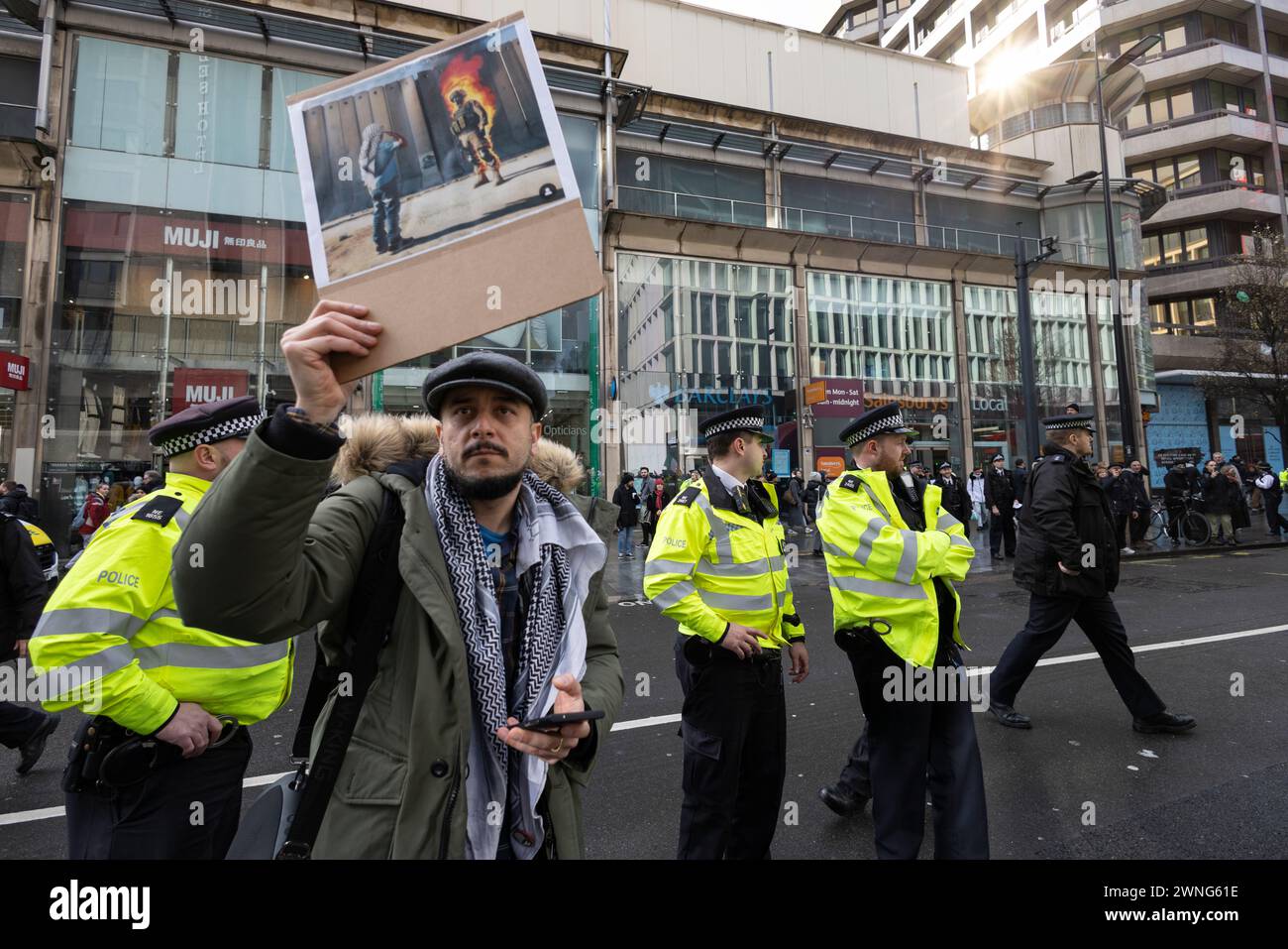 Pro Palestine activists outside Barclays Bank on Tottenham Court Road protest against the bank investing in companies supplying weapons to Israel, UK Stock Photo