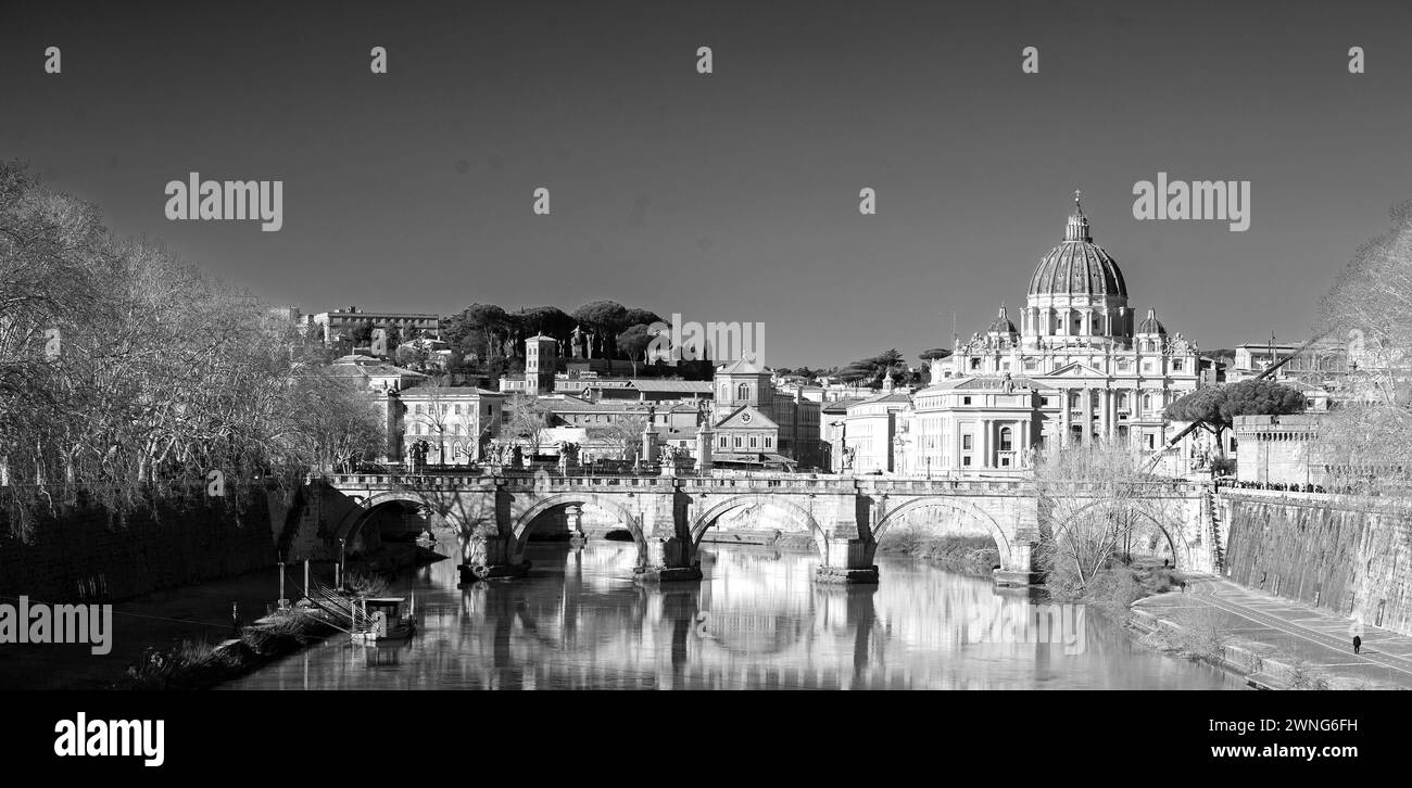 The River Tiber with historic building reflecting in the calm blue water, with St Peter's Basilica in the distance. It is Italy's third longest river. Stock Photo