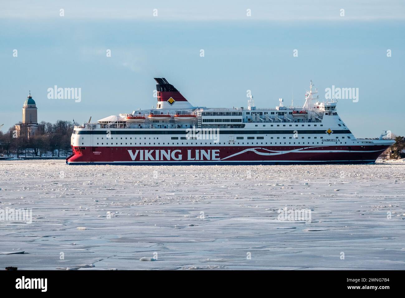 Helsinki / Finland - FEBRUARY 19, 2024: Passenger car ferry MV Gabriella, operated by Viking Line, passing the strait of Kustaanmiekka on clear winter Stock Photo