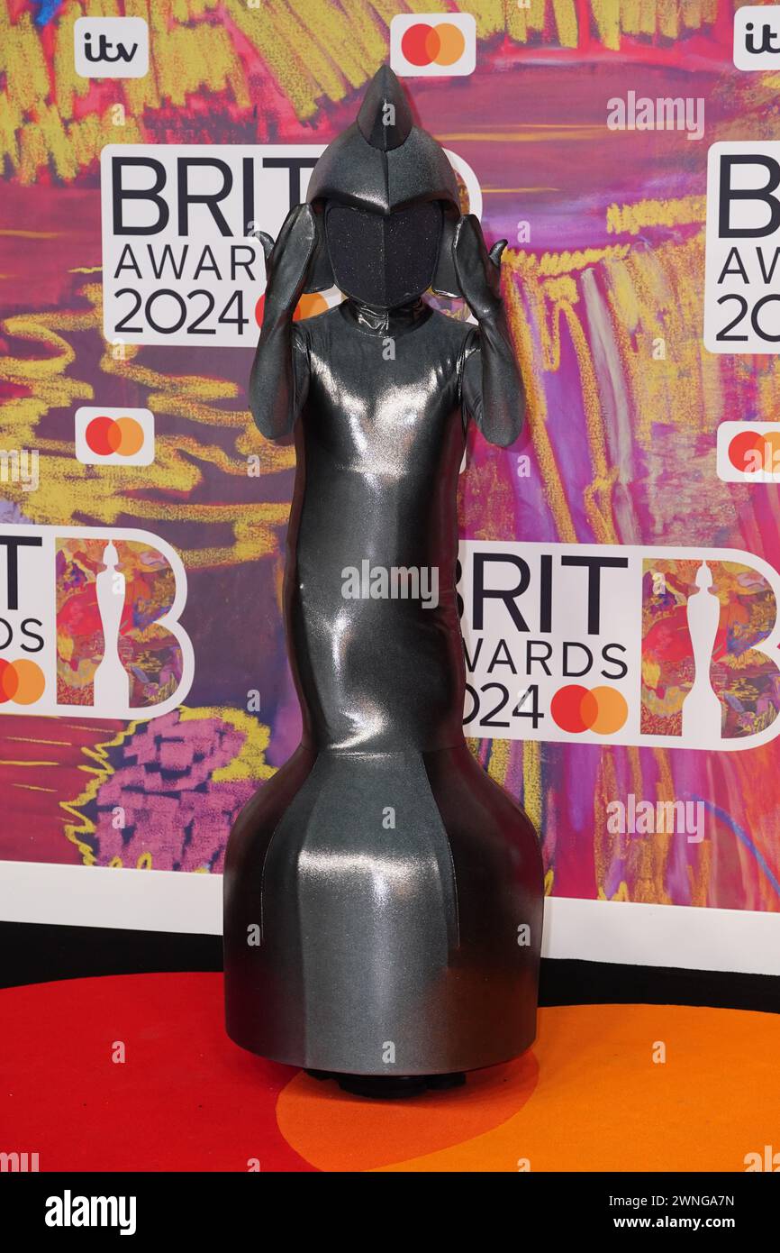 Guest dressed as the Brit Awards trophy attending the Brit Awards 2024 at the O2 Arena, London. Picture date: Saturday March 2, 2024. Stock Photo