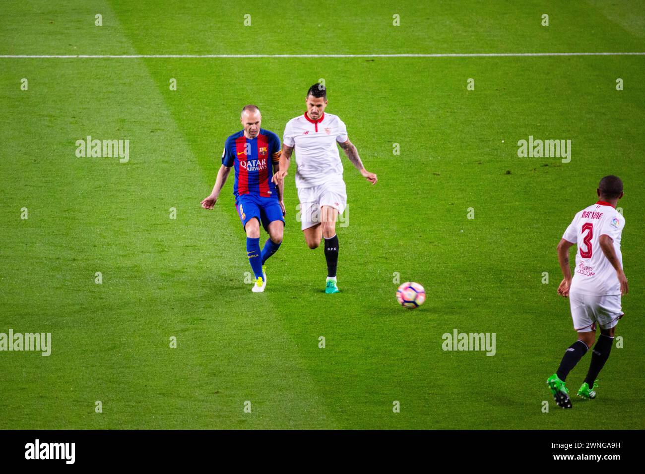 INIESTA, BARCELONA FC, 2017: Andrés Iniesta challenges Vitolo for the ball. Barcelona FC v Sevilla FC at Camp Nou, Barcelona on 5 April 2017. Photo: Rob Watkins. Barca won the game 3-0 with three goals in the first 33 minutes. The game was played in a deluge of rain during a massive spring storm. Stock Photo