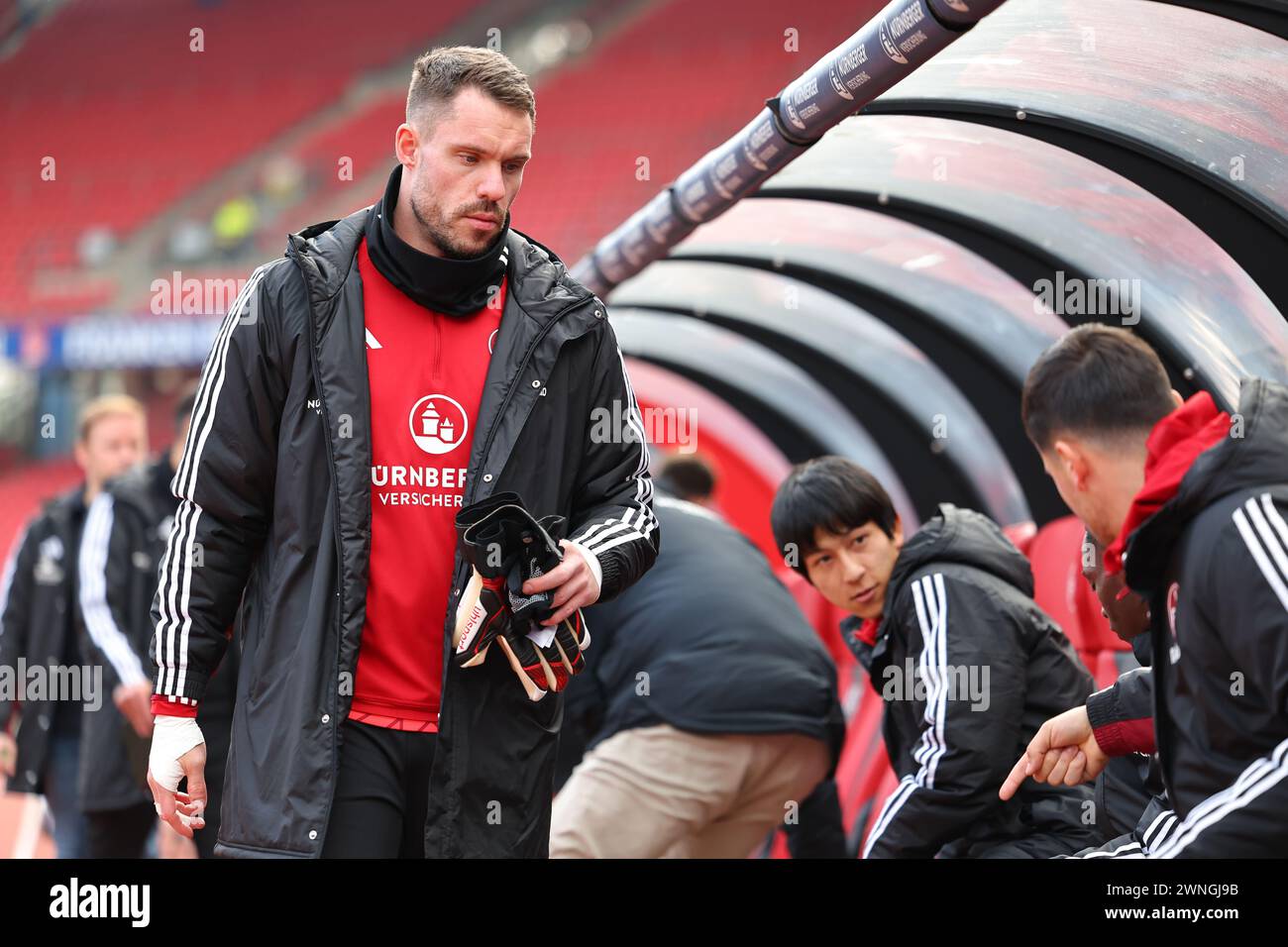 Nuremberg, Germany. 02nd Mar, 2024. Soccer: Bundesliga 2, 1. FC Nuremberg - Eintracht Braunschweig, matchday 24 at the Max Morlock Stadium. Nuremberg goalkeeper Christian Mathenia comes to the substitutes' bench at the start of the match. Credit: Daniel Karmann/dpa - IMPORTANT NOTE: In accordance with the regulations of the DFL German Football League and the DFB German Football Association, it is prohibited to utilize or have utilized photographs taken in the stadium and/or of the match in the form of sequential images and/or video-like photo series./dpa/Alamy Live News Stock Photo