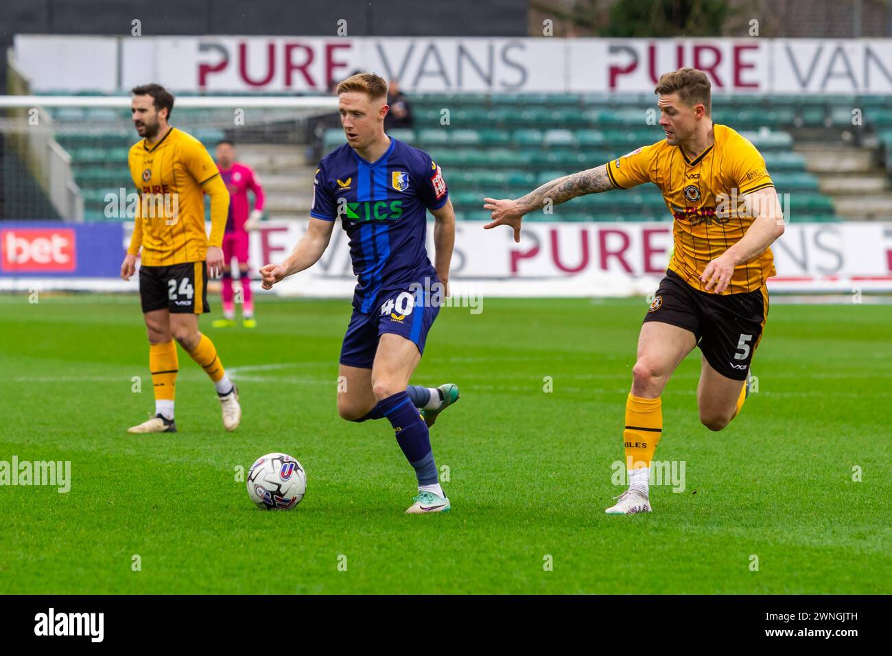 Newport, UK. 02nd Mar, 2024. Davis Keillor-Dunn of Mansfield Town under pressure from James Clarke of Newport County during the EFL football league two match, Newport County v Mansfield Town at Rodney Parade in Newport, Wales on Saturday 2nd March 2024. This image may only be used for Editorial purposes. Editorial use only, pic by Credit: Andrew Orchard sports photography/Alamy Live News Stock Photo