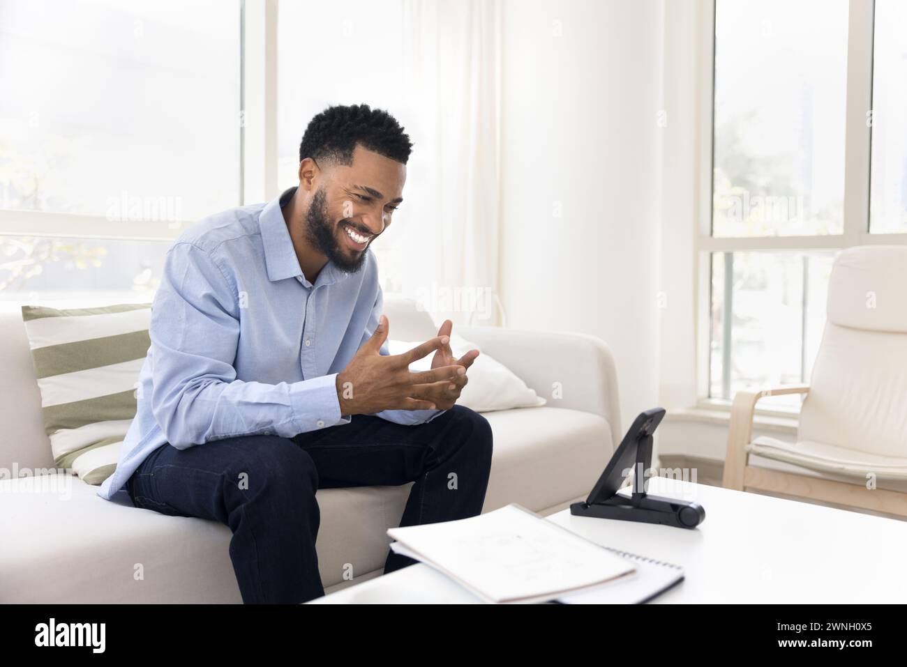 Happy handsome African student man talking to teacher Stock Photo