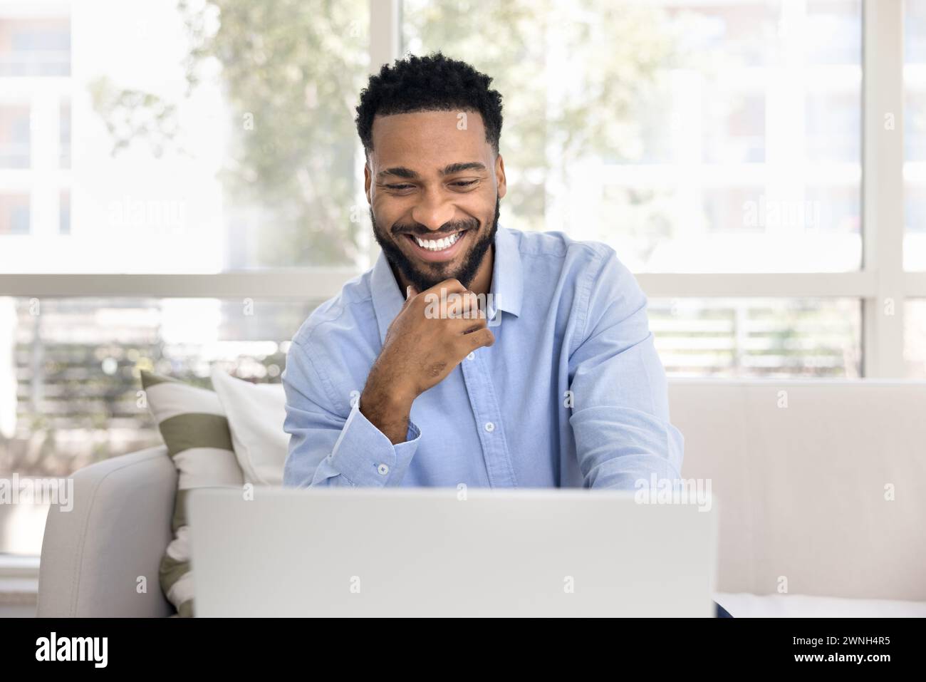 Happy successful African freelancer man working from home Stock Photo