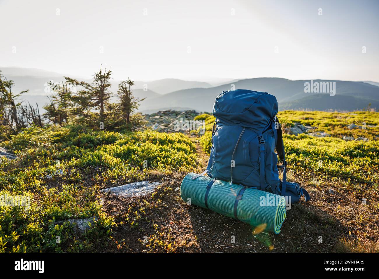 Backpack with sleeping pad. Hiking and trekking equipment in mountains. Travel and camping in nature Stock Photo