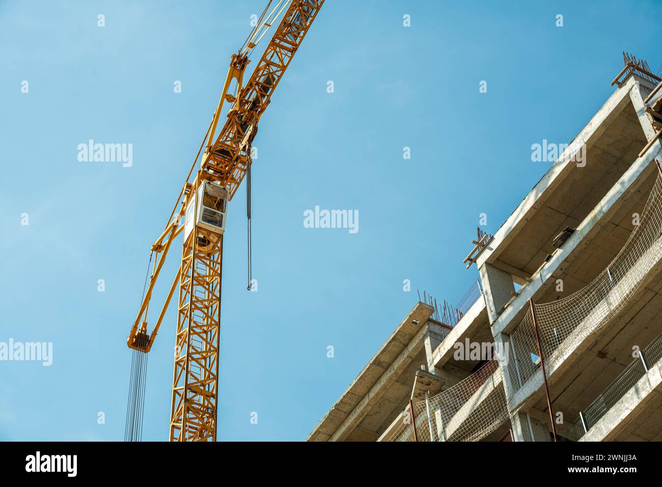 Construction crane working on large construction site Stock Photo