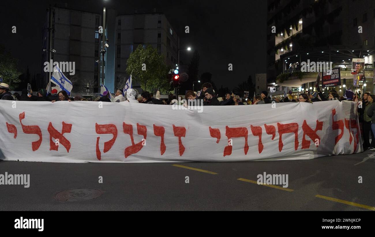 Protestors hold a banner that reads 'My sister's voice calls out to me' during a demonstration held by families of Israeli hostages held in Gaza and their supporters near the official residence of Prime Minister, calling for the release of hostages on March 2, 2024 in Jerusalem. Israel Stock Photo