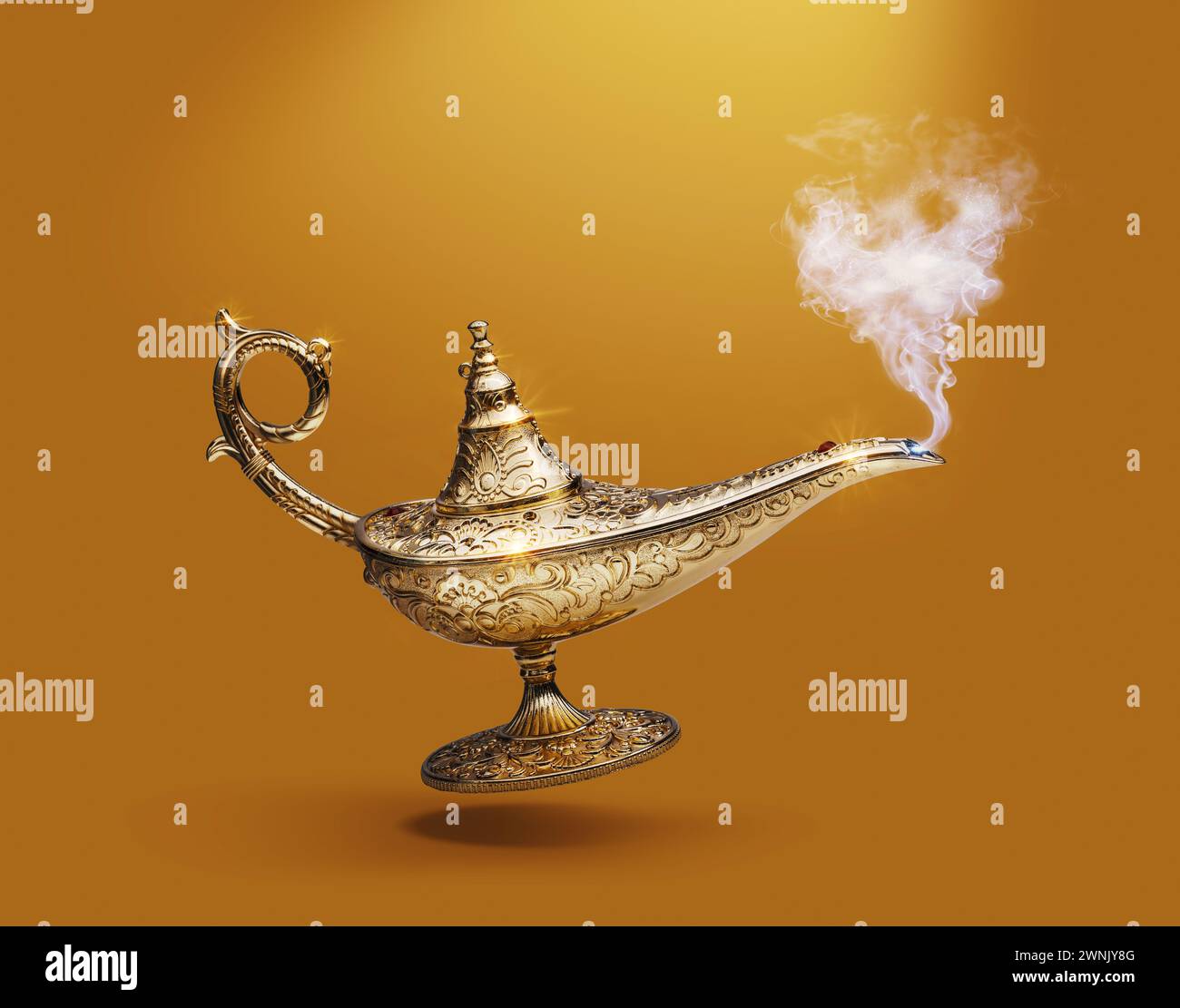 Precious golden magic lamp on gold background, fairy tales and wish fulfillment concept Stock Photo