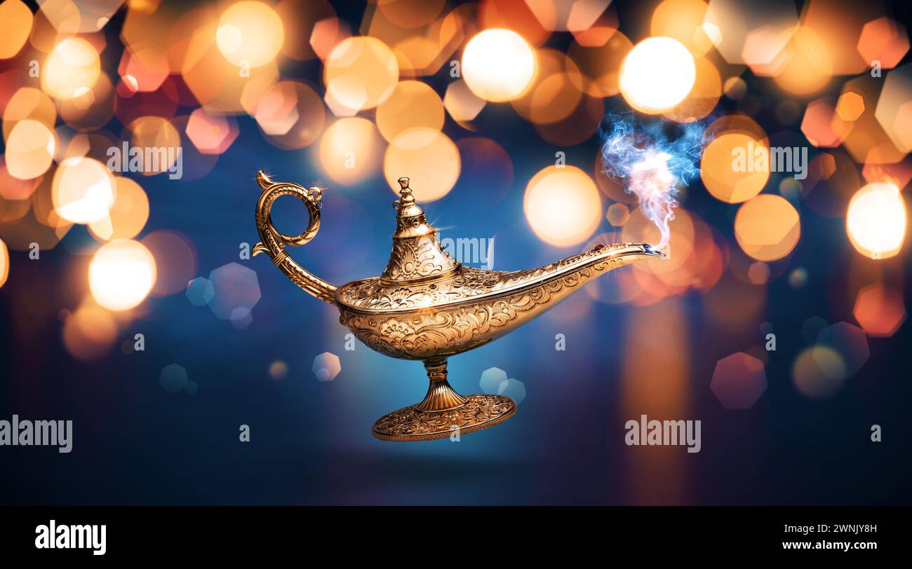 Precious magic lamp with smoke and golden bokeh background, wish fulfillment and fantasy concept Stock Photo