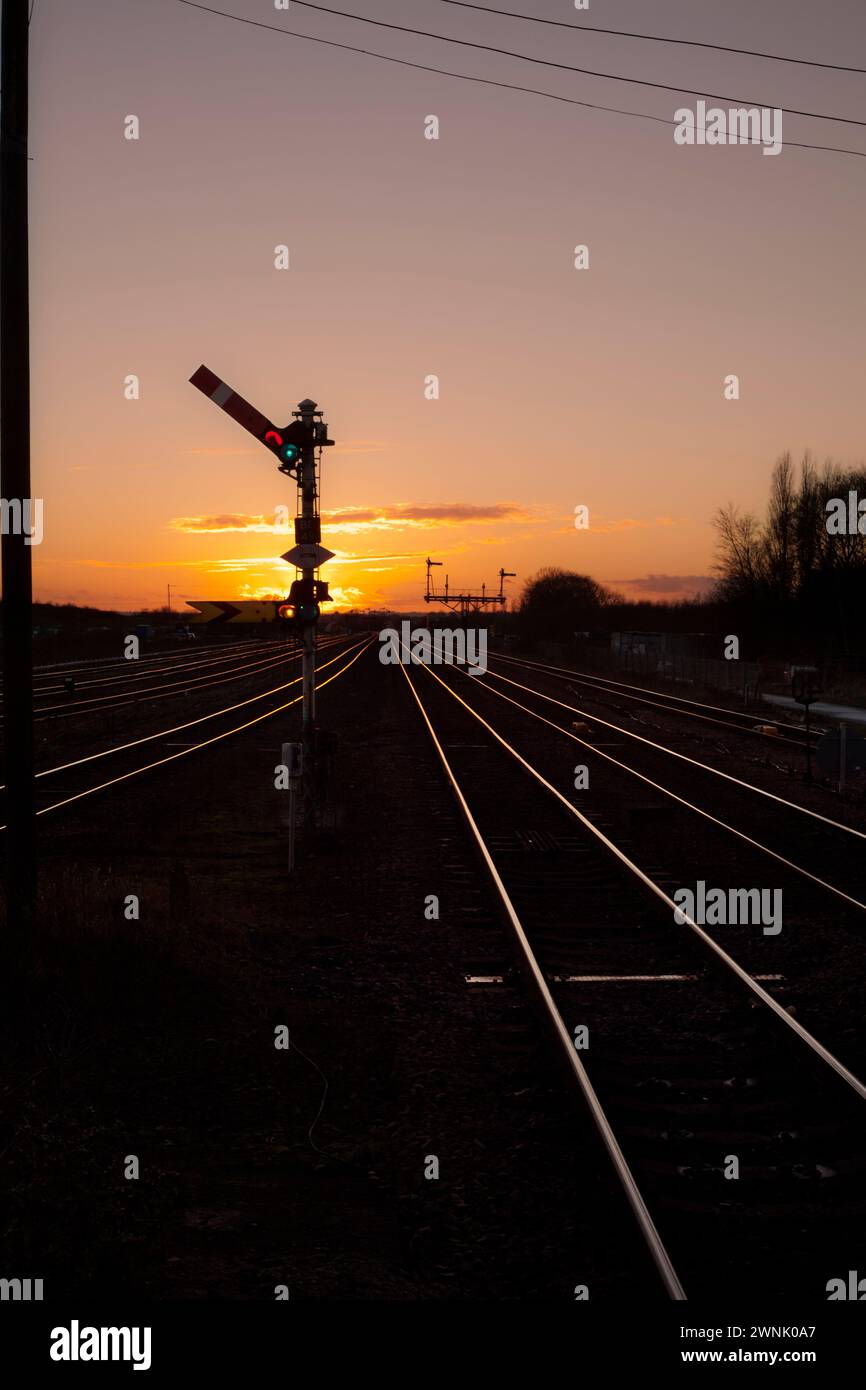 Railway upper quadrant semaphore signals with a golden sunset at Barnetby, Lincolnshire, UK Stock Photo