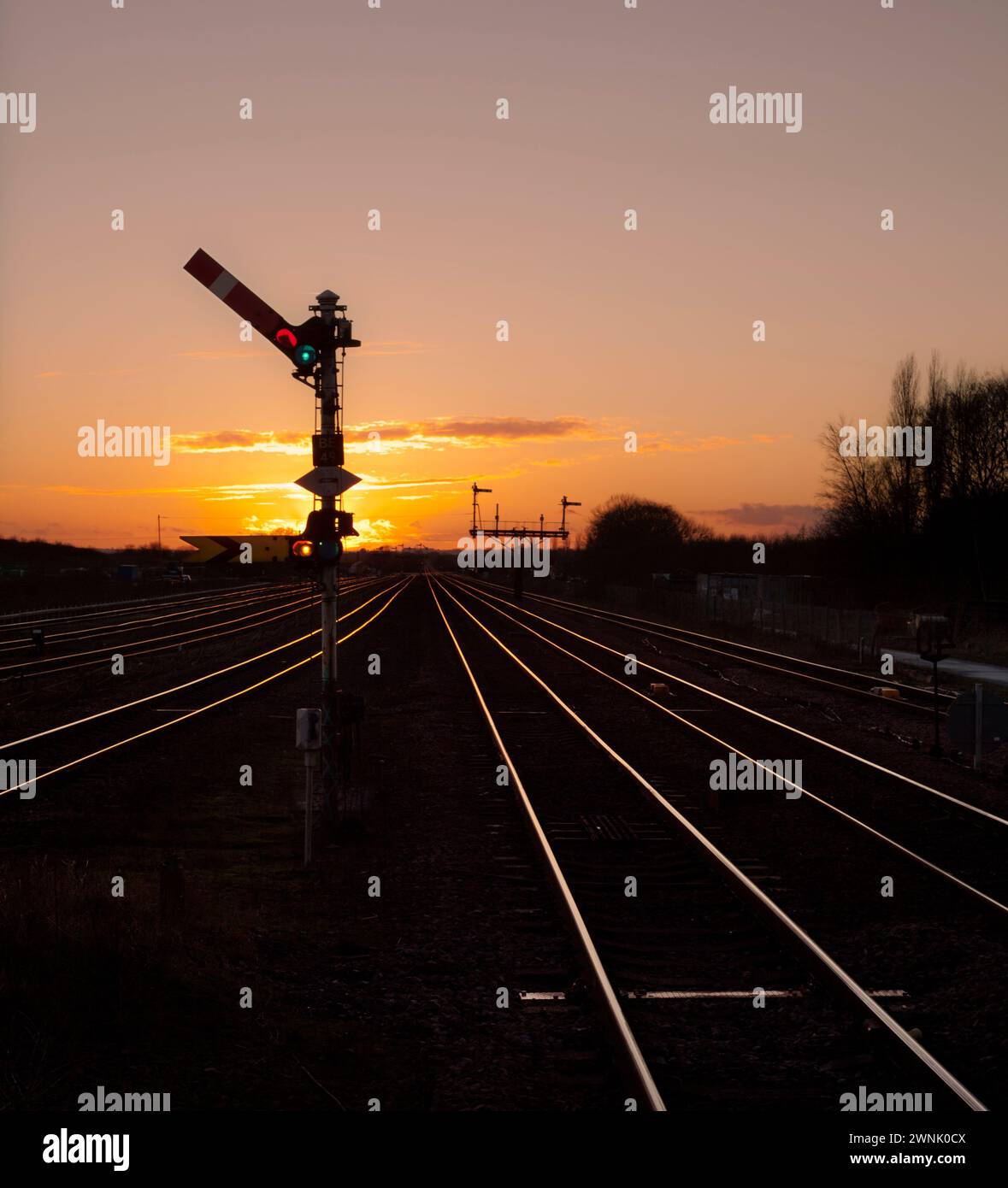 Railway upper quadrant semaphore signals with a golden sunset at Barnetby, Lincolnshire, UK Stock Photo