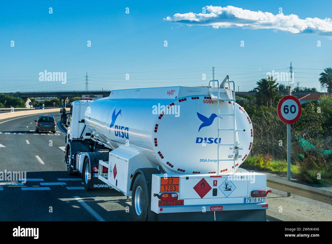 Single-axle fuel tanker truck from the Disa oil company traveling on the highway. Stock Photo