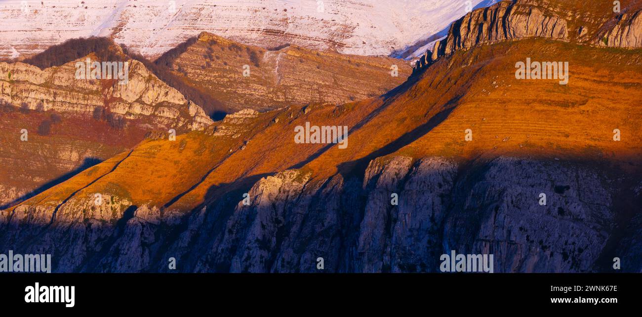 Last lights of the peaks of the Miera Valley in winter, aerial view of the Miera River Valley. Landscape in winter. Valleys Pasiegos. Cantabria. Spain Stock Photo