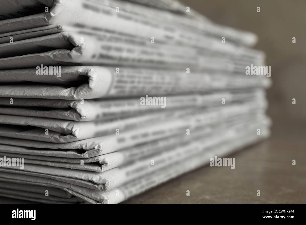 Stack of newspapers on marble table, closeup. Journalist's work Stock Photo