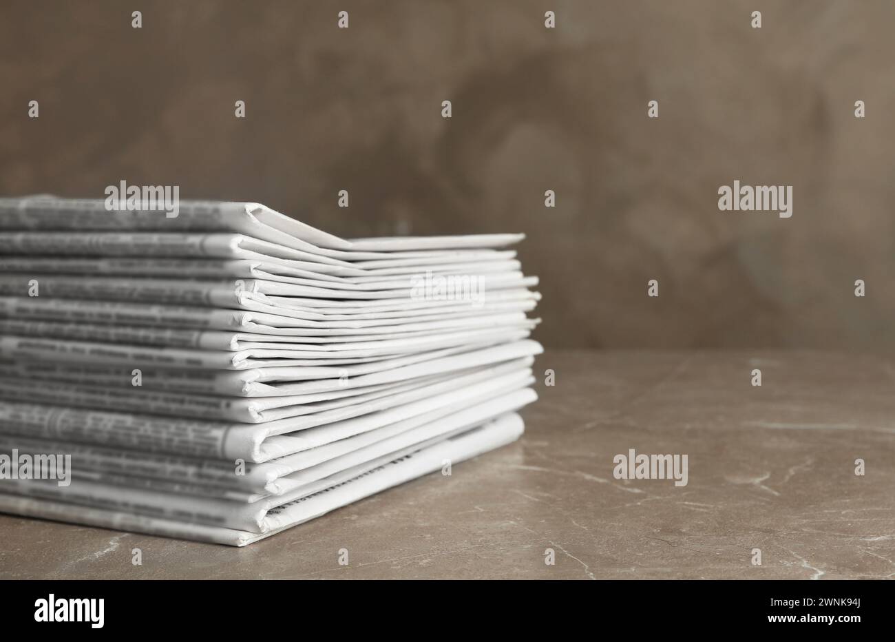 Stack of newspapers on marble table. Journalist's work Stock Photo