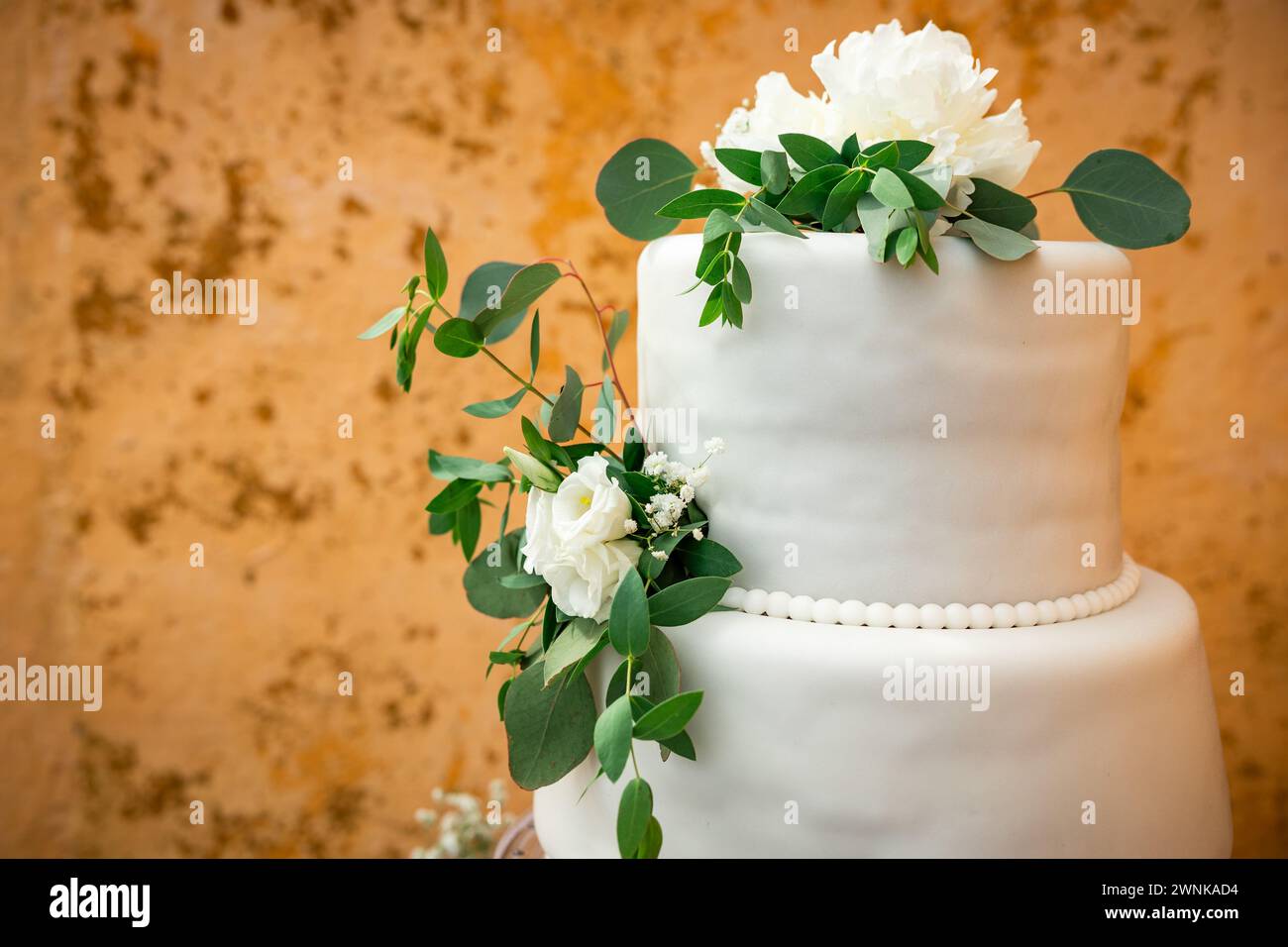 Wedding day details of preparation and reception, white dress with cute flower details and eucaliptus decoration. Stock Photo