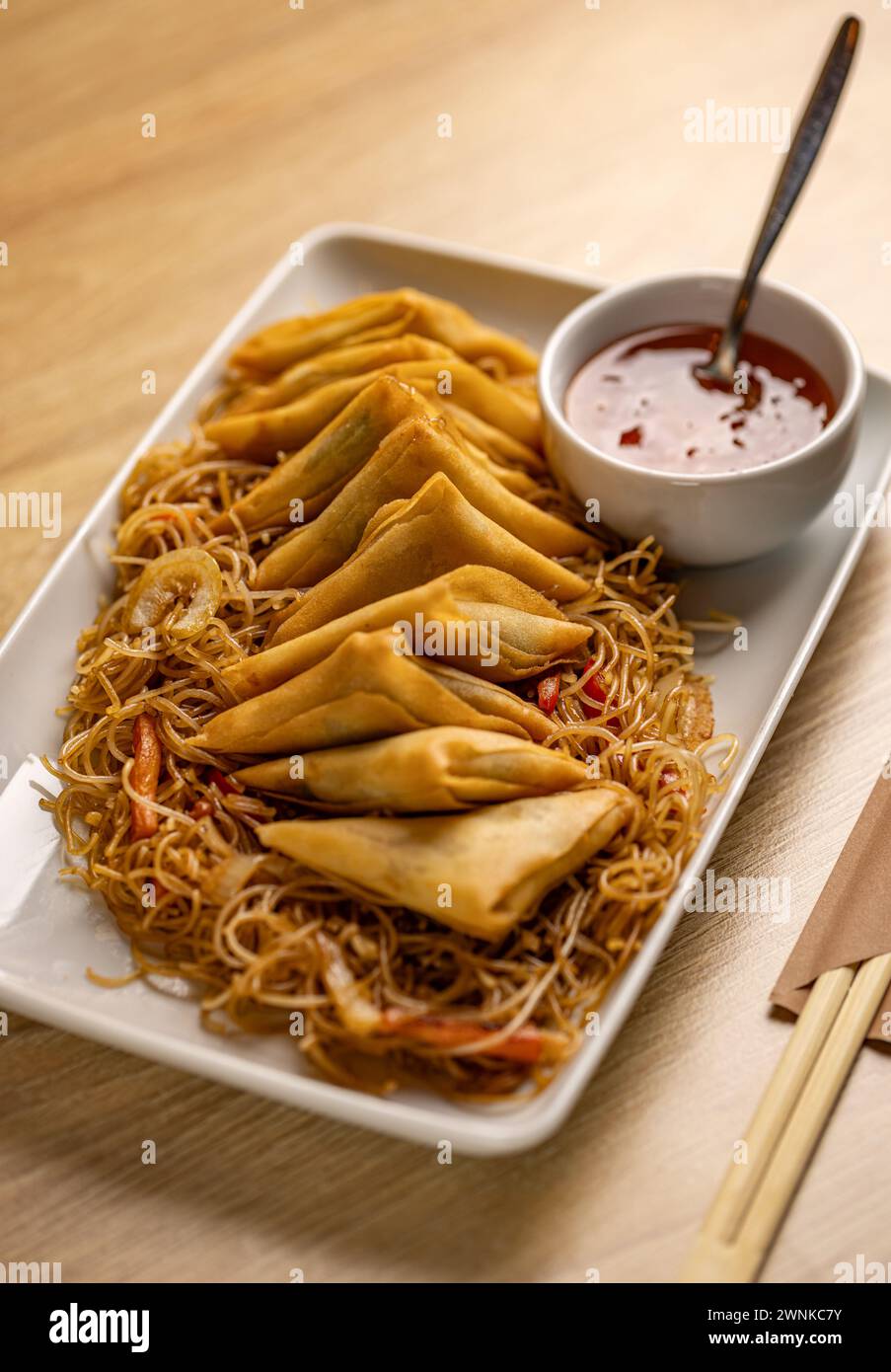 Fresh fried Chinese traditional triangle Spring rolls food with noodles Stock Photo