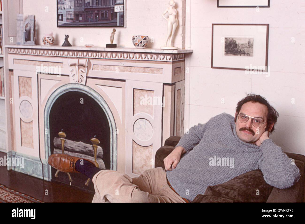 Trompe L'Oiel artist Richard Haas in his loft in Soho, New York City in 1977. The fireplace was one of his paintings. Stock Photo