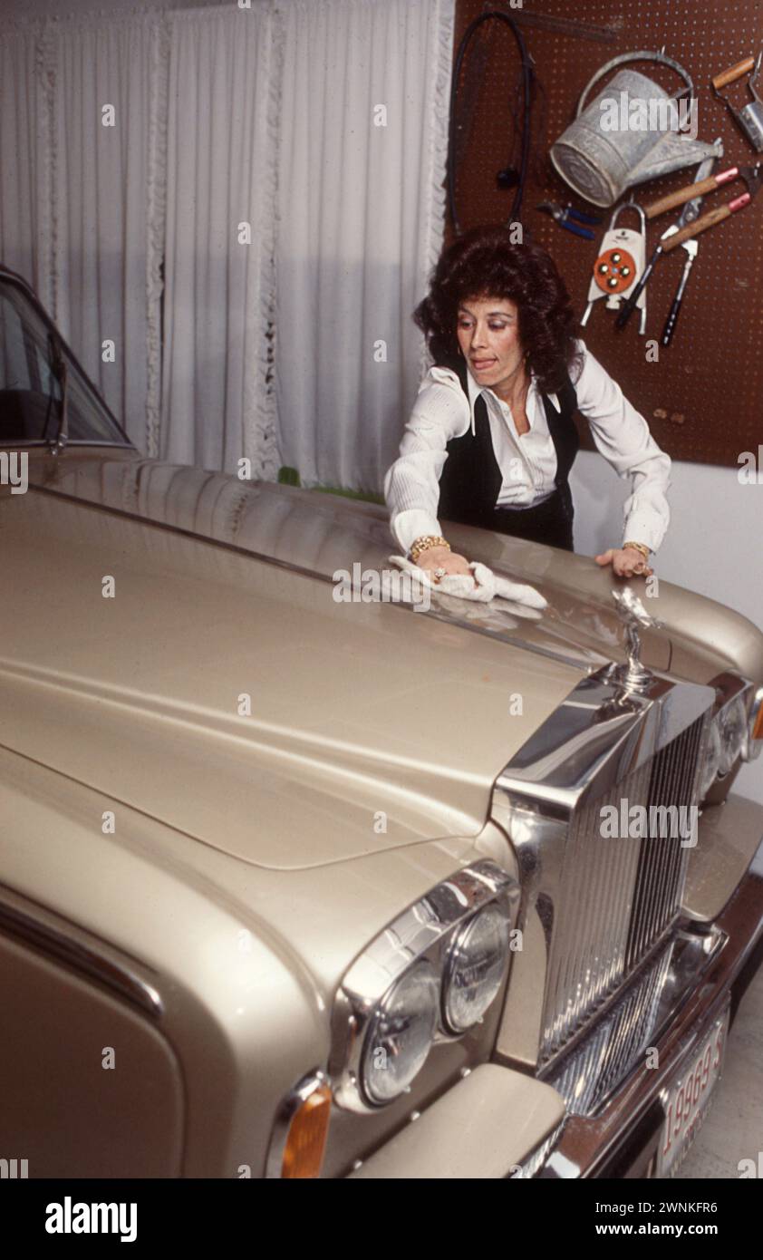 Pete Rose's first wife Karolyn Englehardt cleans the hood of the family's Rolls Royce shortly after her hubby became baseball's first three million dollar man., Stock Photo