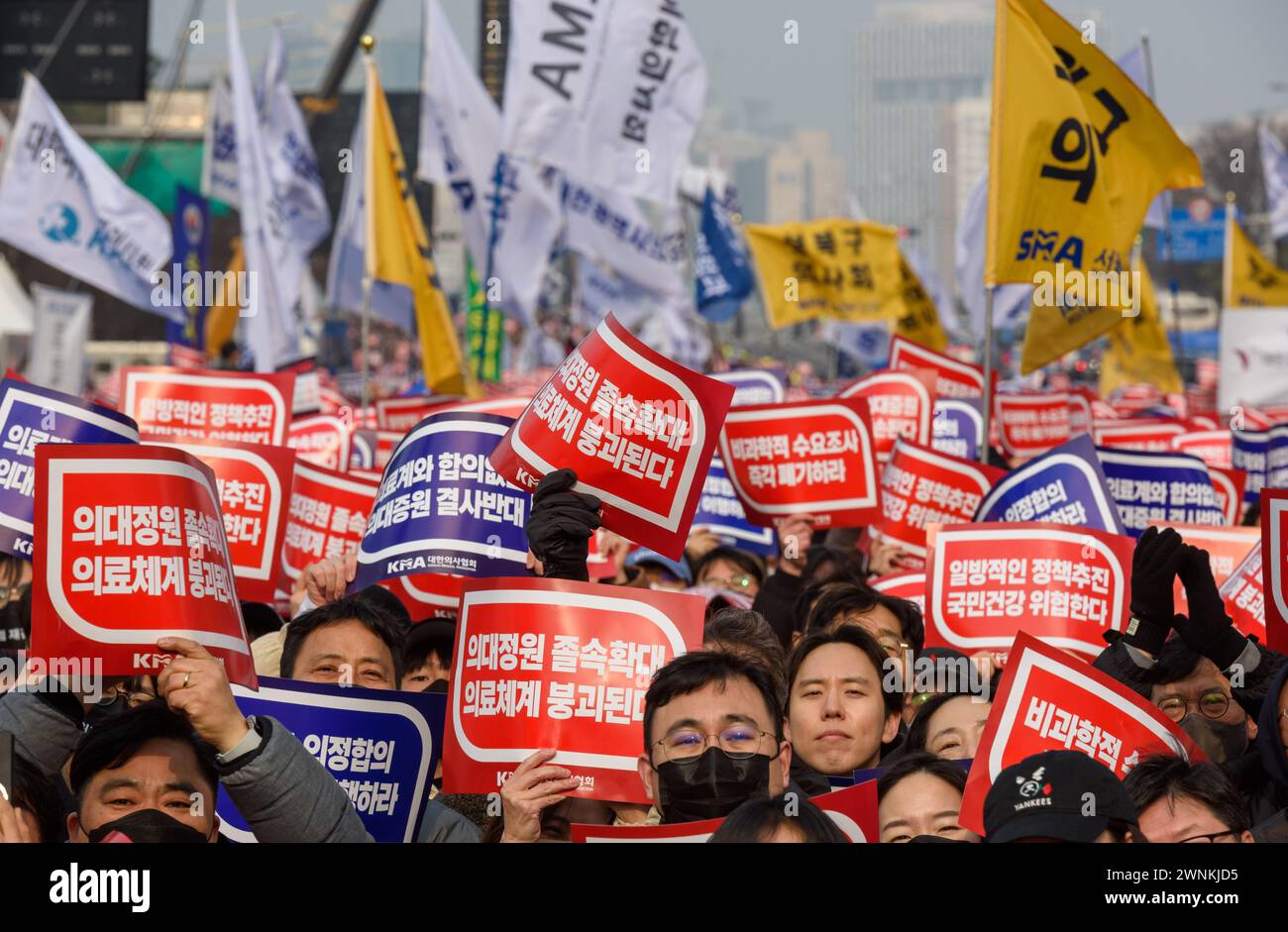 South Korean doctors hold placards saying 'Opposition to the increase in medical schools' during the demonstration. Thousands of senior doctors held a rally in Seoul against the government's medical school quota hike plan as Prime Minister Han Duck-soo hinted at the possible suspension of medical licenses for striking trainee doctors. The rally by members of the Korean Medical Association (KMA), the biggest medical lobby group, came as thousands of trainee doctors have remained off their jobs at general hospitals for the 13th day, protesting the plan to add 2,000 more medical school seats star Stock Photo