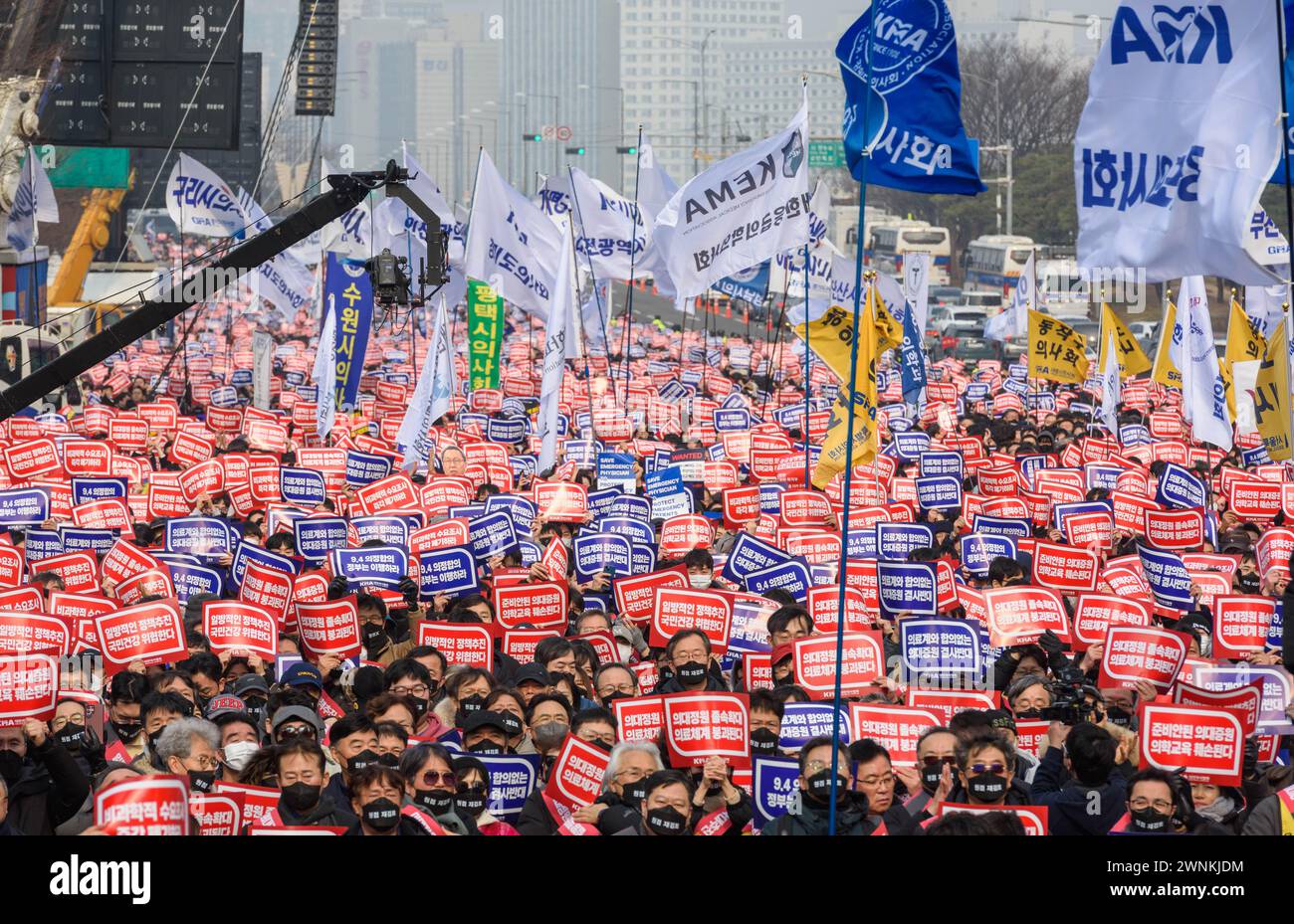South Korean doctors hold placards saying 'Opposition to the increase in medical schools' during the demonstration. Thousands of senior doctors held a rally in Seoul against the government's medical school quota hike plan as Prime Minister Han Duck-soo hinted at the possible suspension of medical licenses for striking trainee doctors. The rally by members of the Korean Medical Association (KMA), the biggest medical lobby group, came as thousands of trainee doctors have remained off their jobs at general hospitals for the 13th day, protesting the plan to add 2,000 more medical school seats star Stock Photo