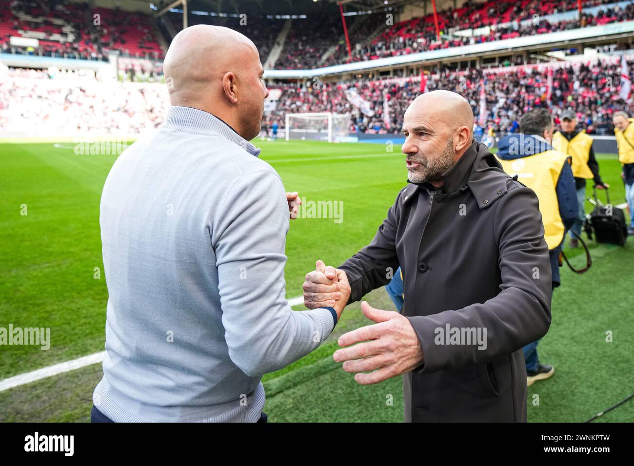 Eindhoven, The Netherlands. 03rd Mar, 2024. Eindhoven - Feyenoord coach Arne Slot, PSV Eindhoven coach Peter Bosz during the Eredivisie match between PSV v Feyenoord at Philips Stadion on 3 March 2024 in Eindhoven, The Netherlands. Credit: box to box pictures/Alamy Live News Stock Photo