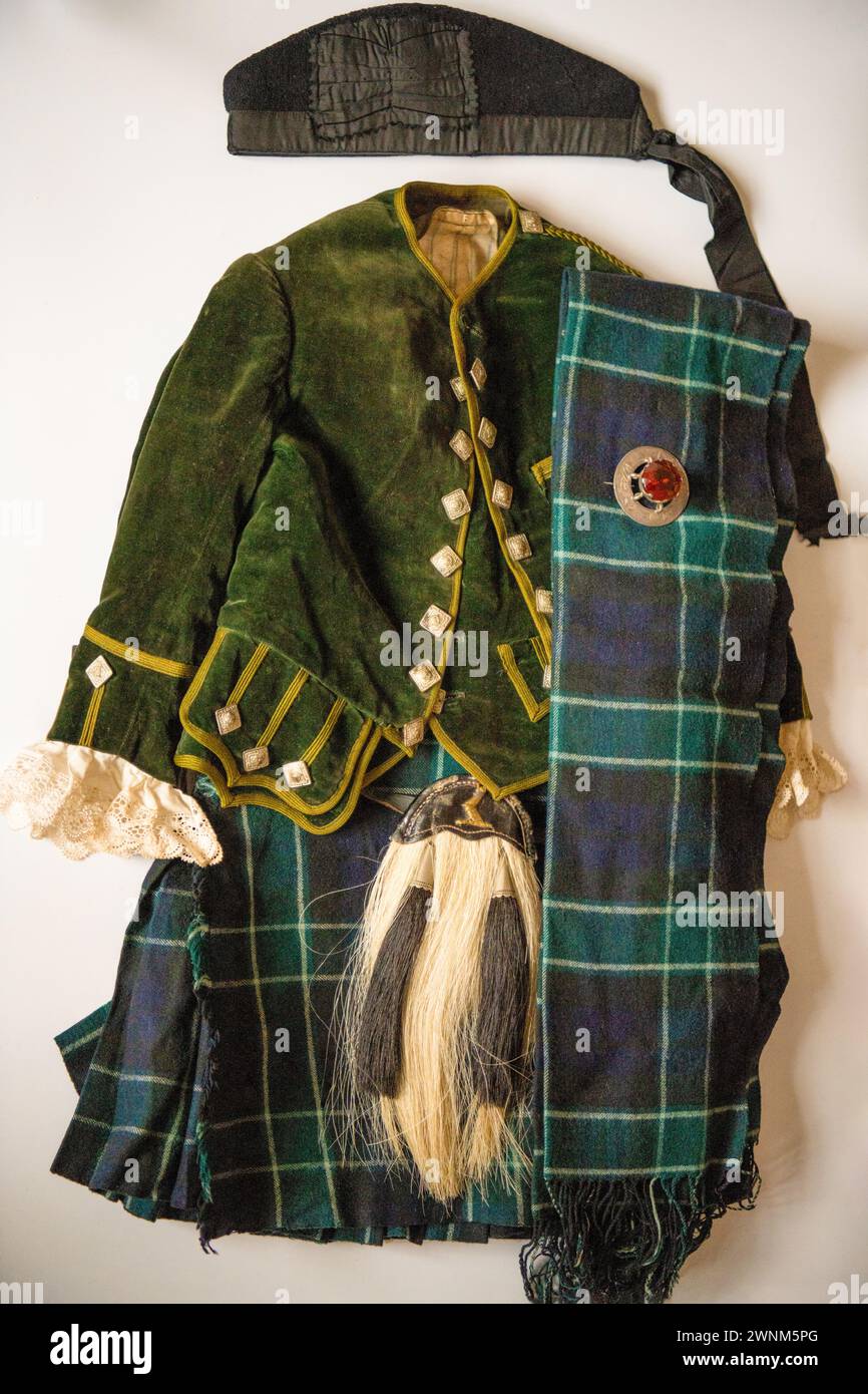Four year's olds vintage Scottish clan outfit, of about 1910. Tartan unknown with Scottish Brooch, Kilt, Jacket, Glengarry Bonnet, Sash & Sporran. Stock Photo