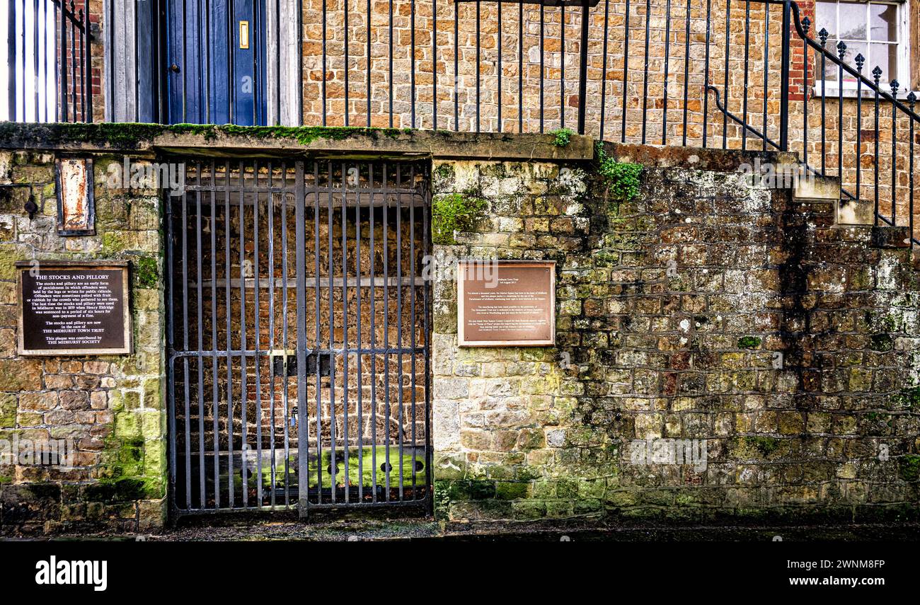 Fenced off historic stocks and pillory preserved in the English market town of Midhurst, West Sussex, England. Stock Photo