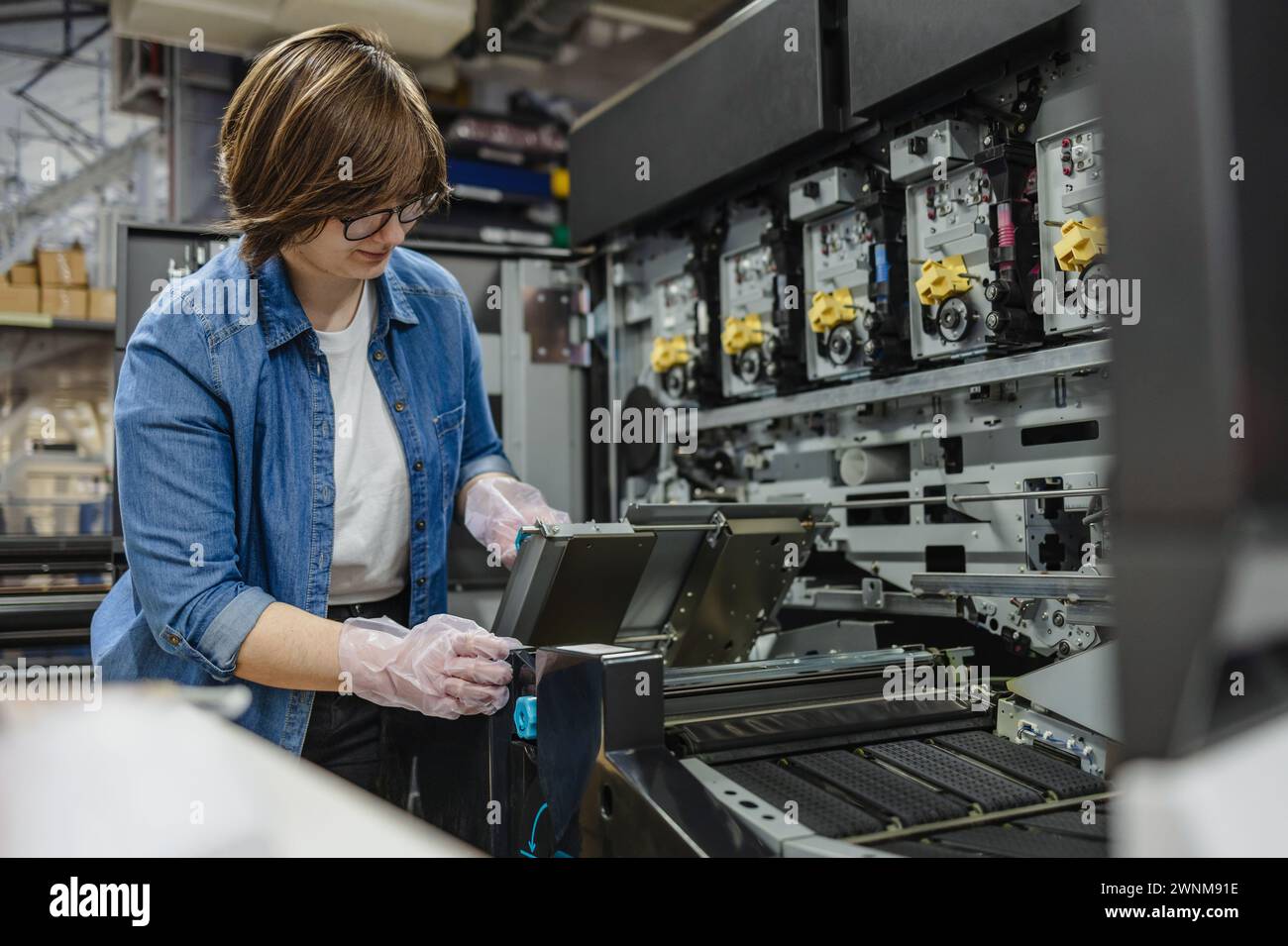 Woman working in a printing factory Stock Photo
