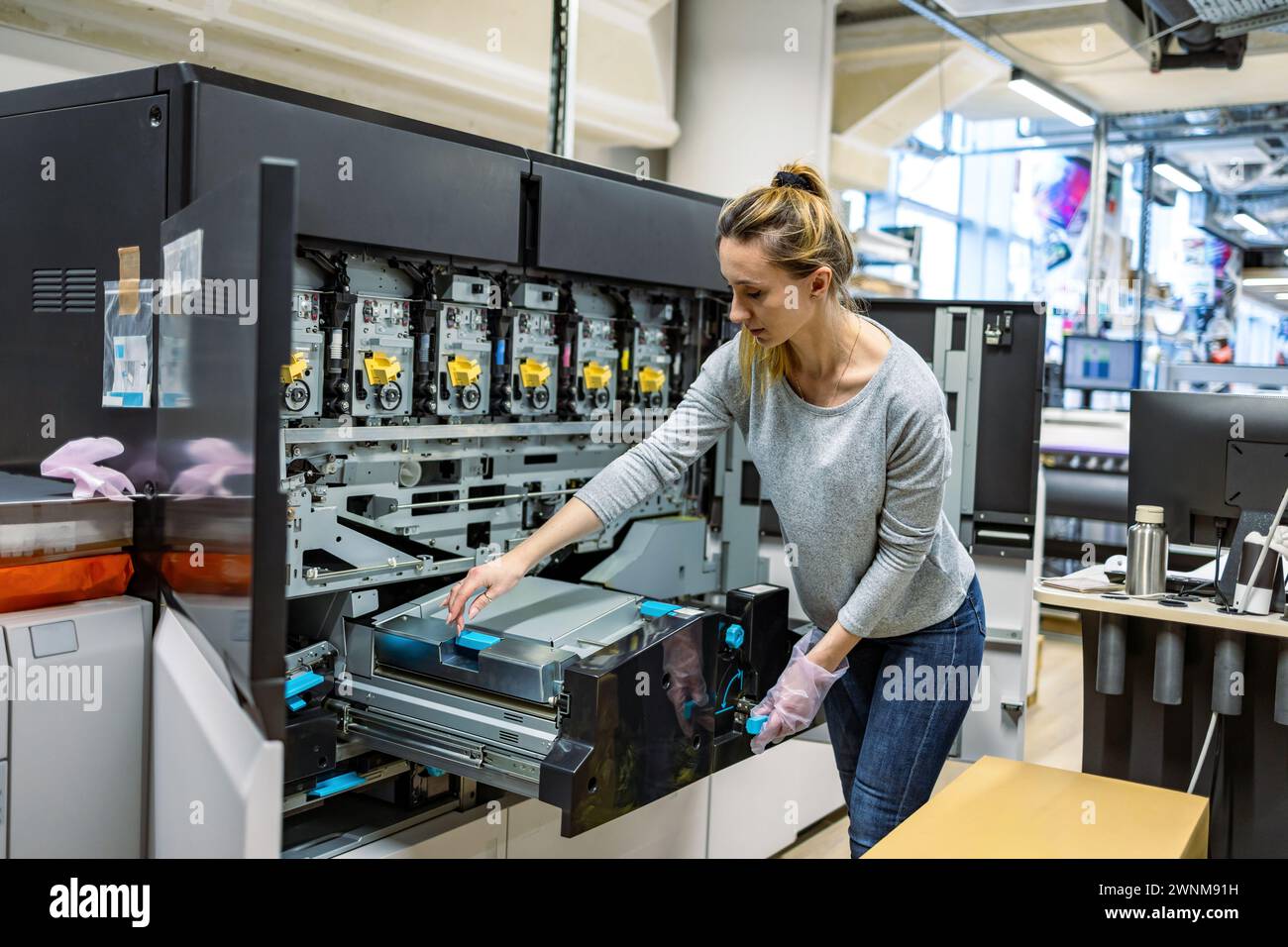 Woman working in a printing factory Stock Photo