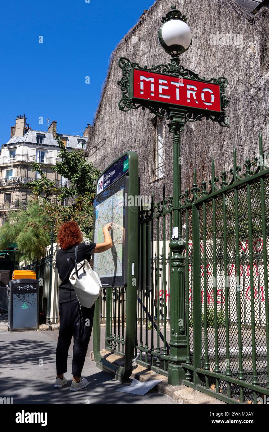 Tourist at the metro stop consulting the city map, Paris, France, Europe, M.R. Stock Photo
