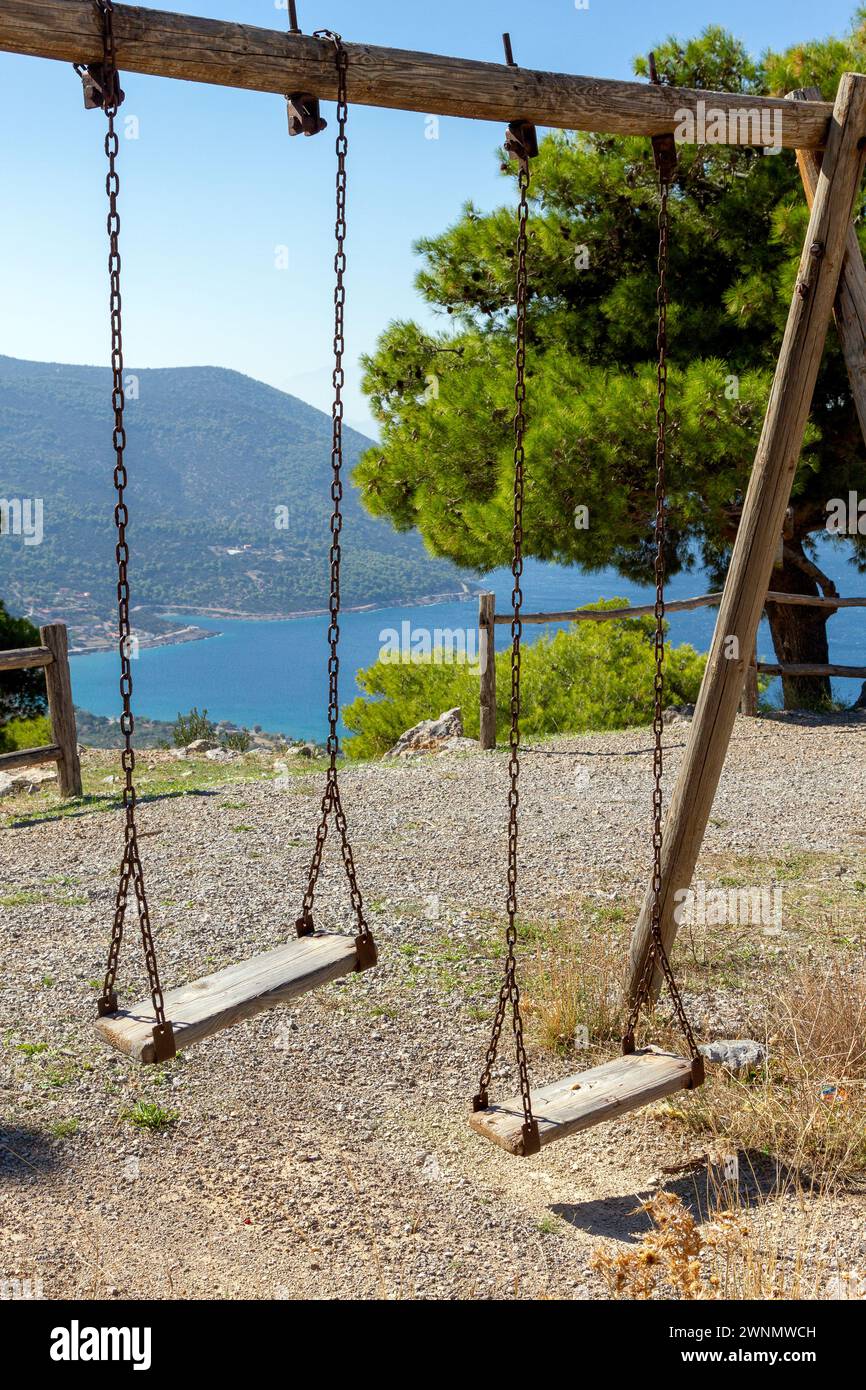 Wooden playground swings in a open air playground near Porto Germeno town, in western Attica region, near Athens, Greece. Stock Photo