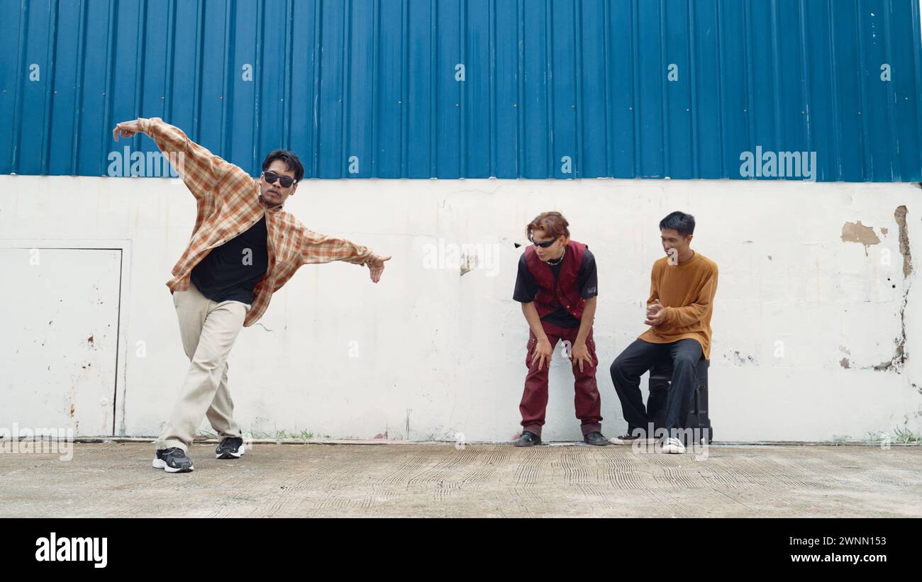 Young street dancer dancing in hip hop style with multicultural friends ...