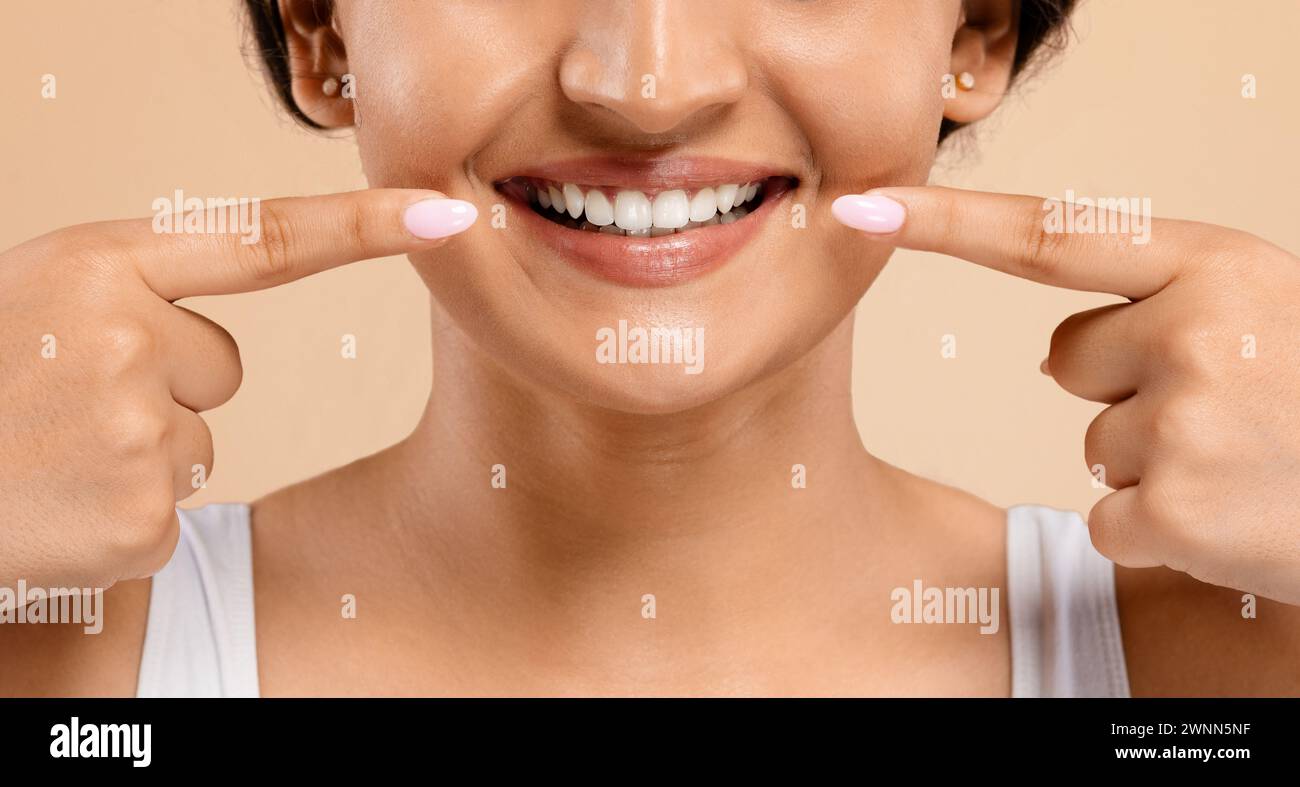 Oral Care. Beautiful Young Indian Woman Pointing At Her White Smile Stock Photo