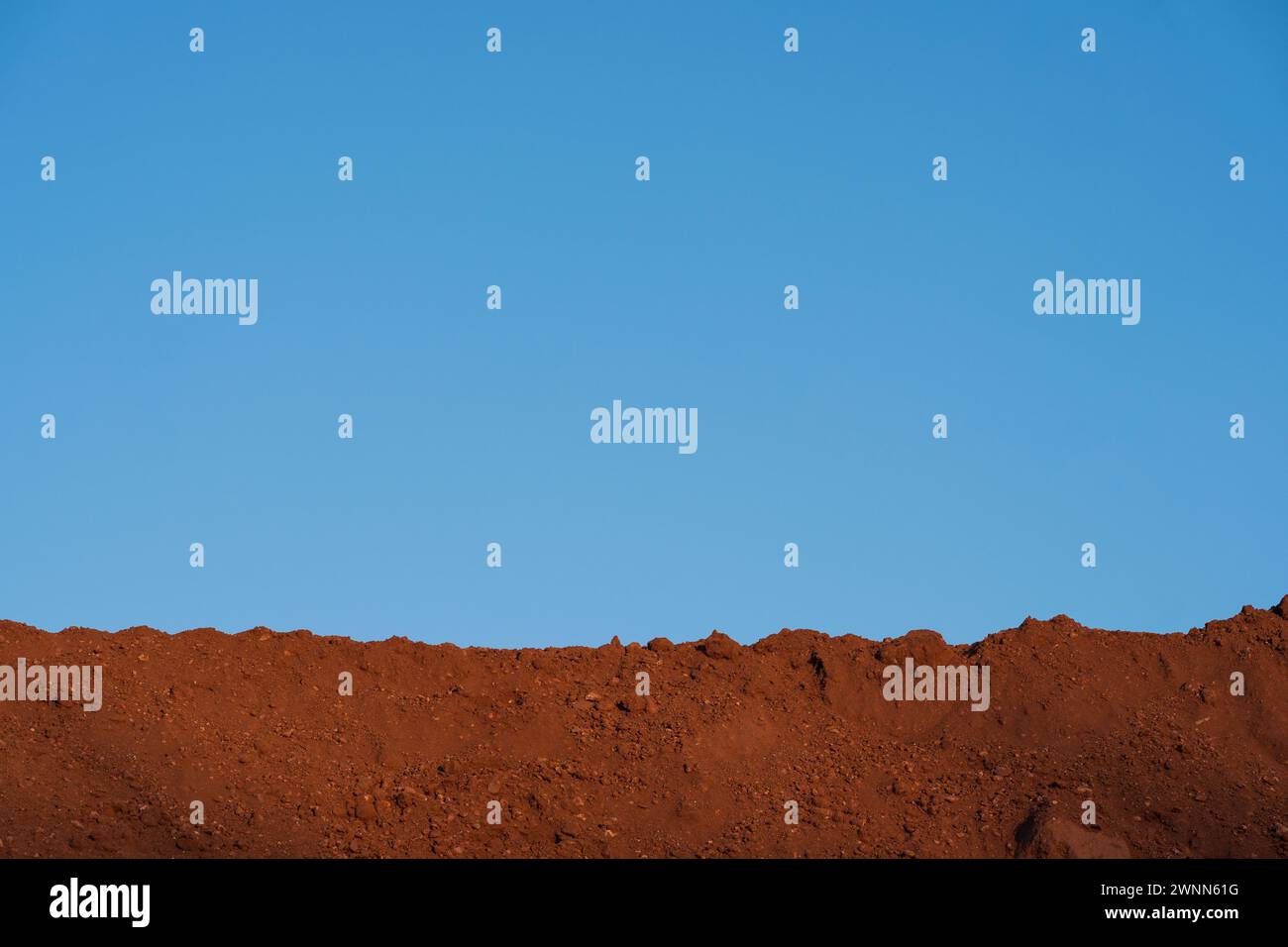Earthy horizons. Brown dirt soil and blue sky . A Planet earth concept. Stock Photo