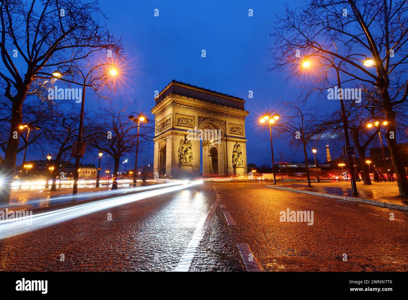 The Triumphal Arch in rainy evening. It is one of the most famous ...